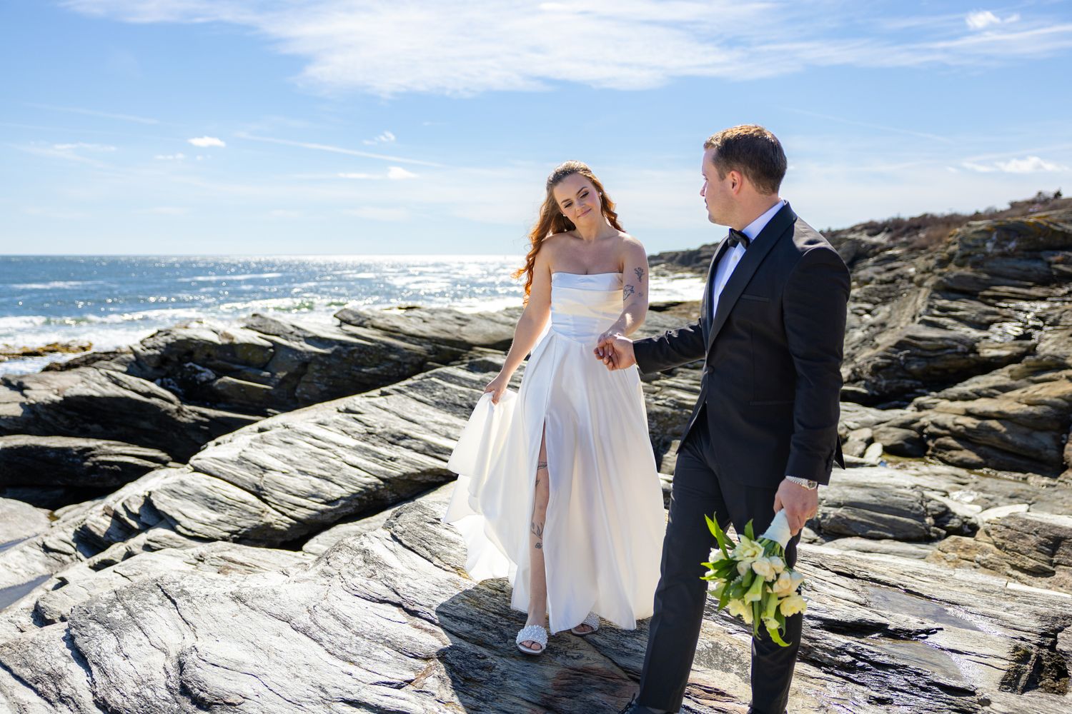 A romantic wedding photo series at a rustic stone venue with red doors and natural greenery surroundings.