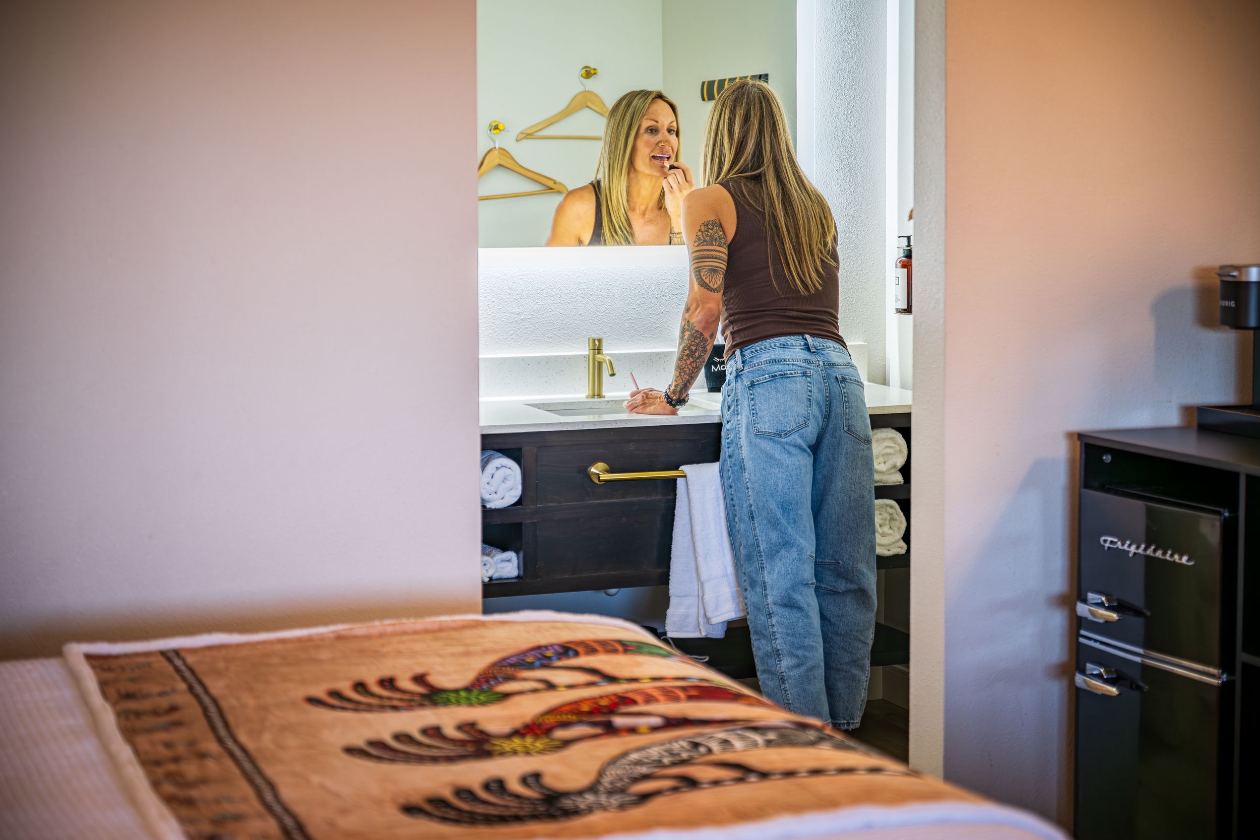 Shot of a woman applying makeup in a luxury hotel room, The Kokopelli Inn in Sedona, AZ.