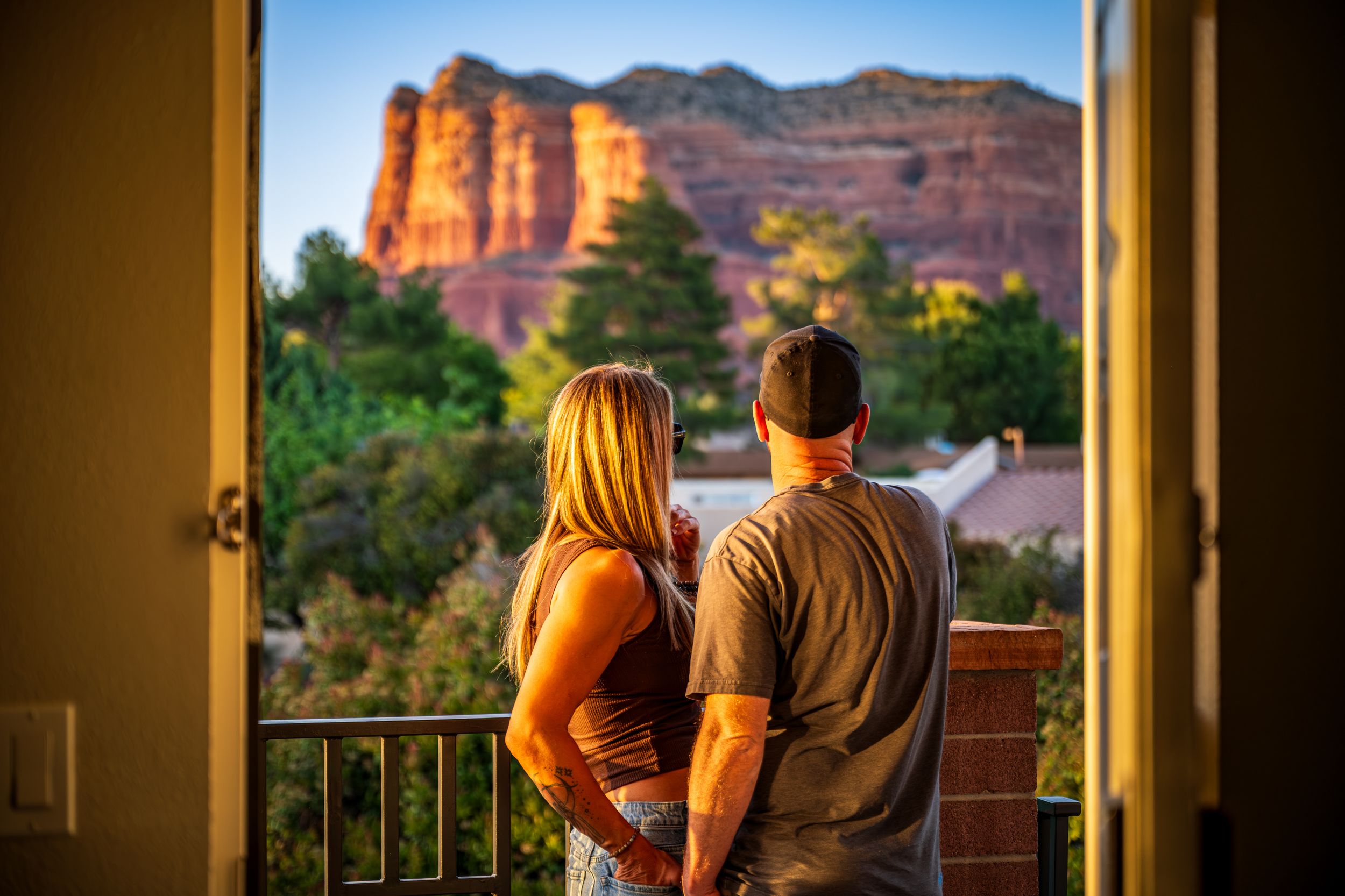 Shot of a couple enjoying the red rock views from a luxury hotel room, The Kokopelli Inn in Sedona, AZ.