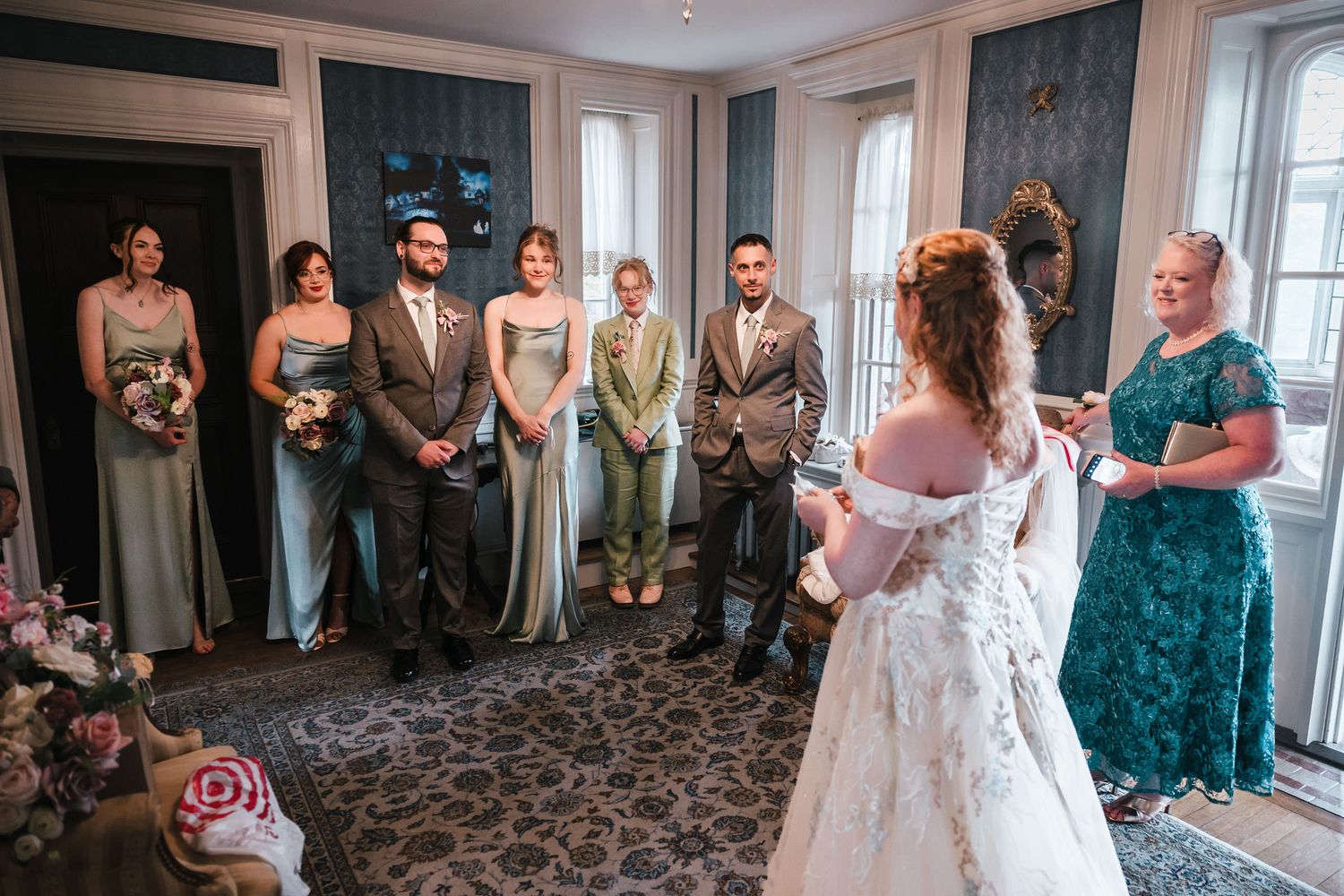 Bride addressing her full bridal party in a room at Searles Castle, moments before giving each of them a handmade gift.