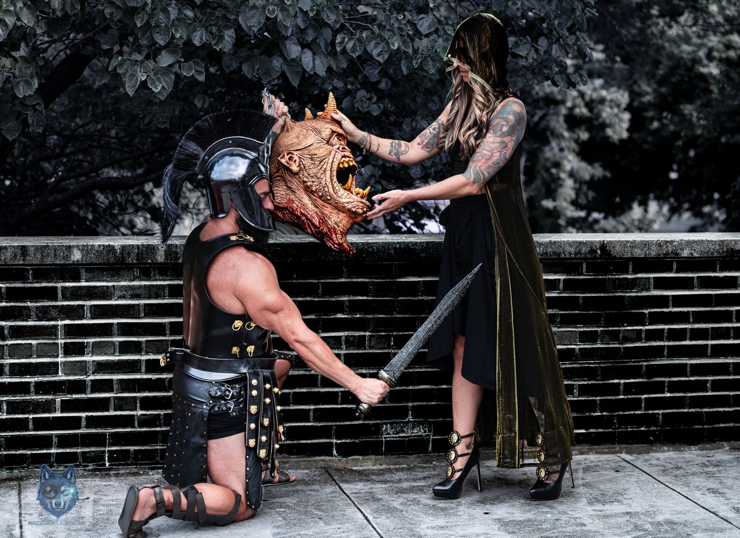 Fantasy cosplay shoot with gladiator kneeling before hooded woman holding monster mask. Chi.Shooters meet tonybrettman tattoo_jessie