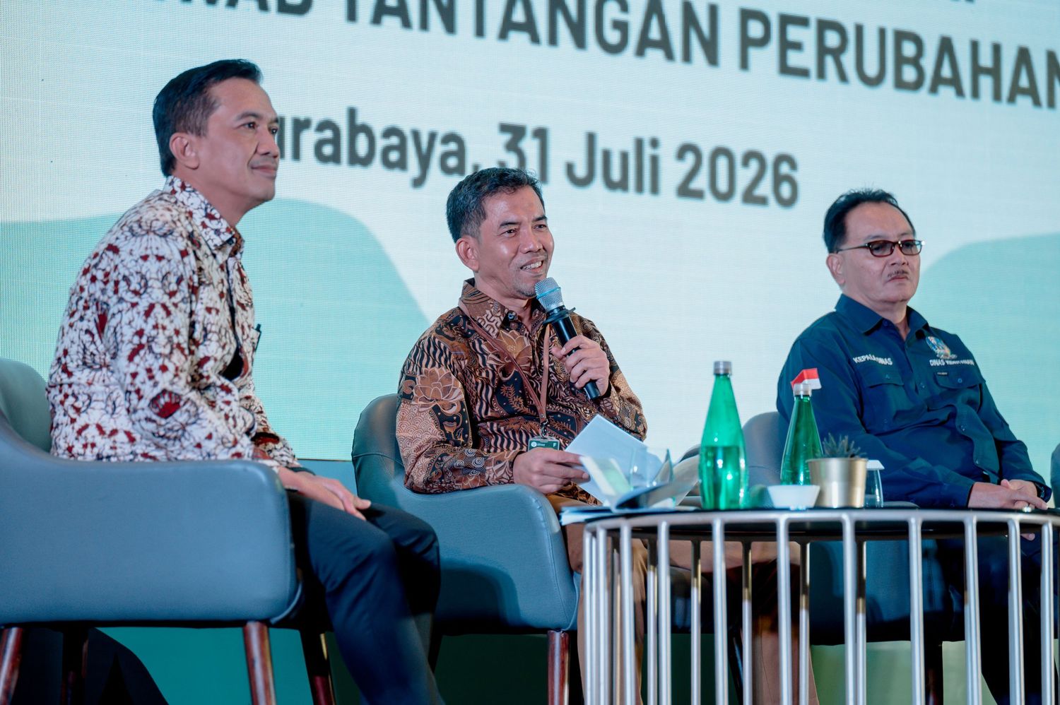 Three men in batik shirts speak at a panel discussion in Surabaya on July 31, 2026, at a leadership conference.