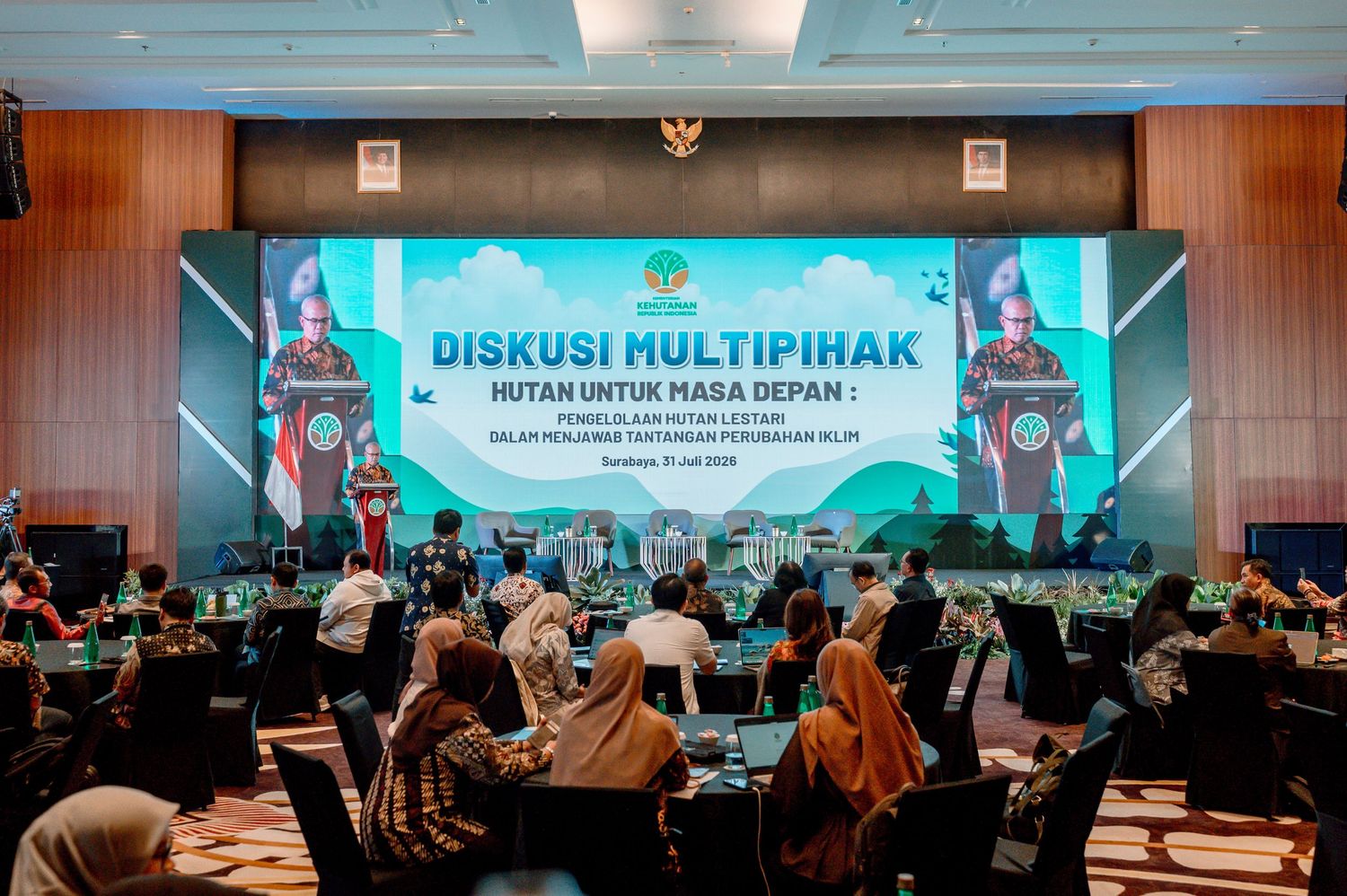 Multi-stakeholder discussion forum on forest conservation held in a conference room in Indonesia.