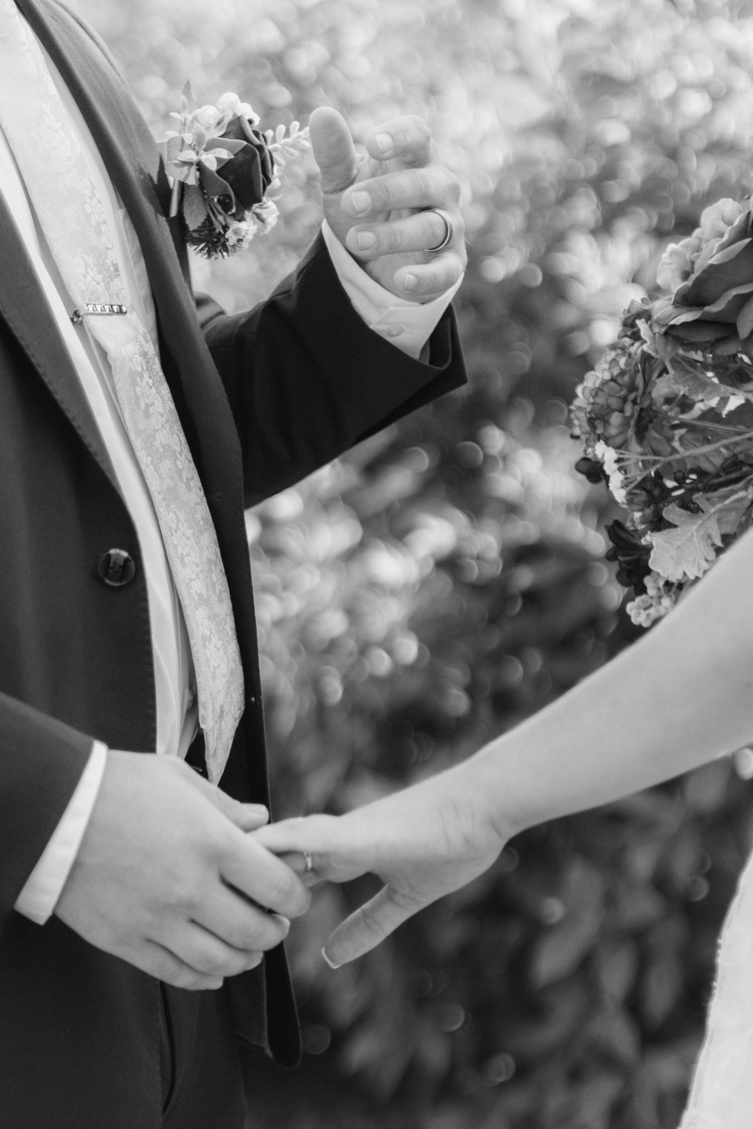 First look with bride and groom holding hands in front of Brigham City LDS temple in Utah