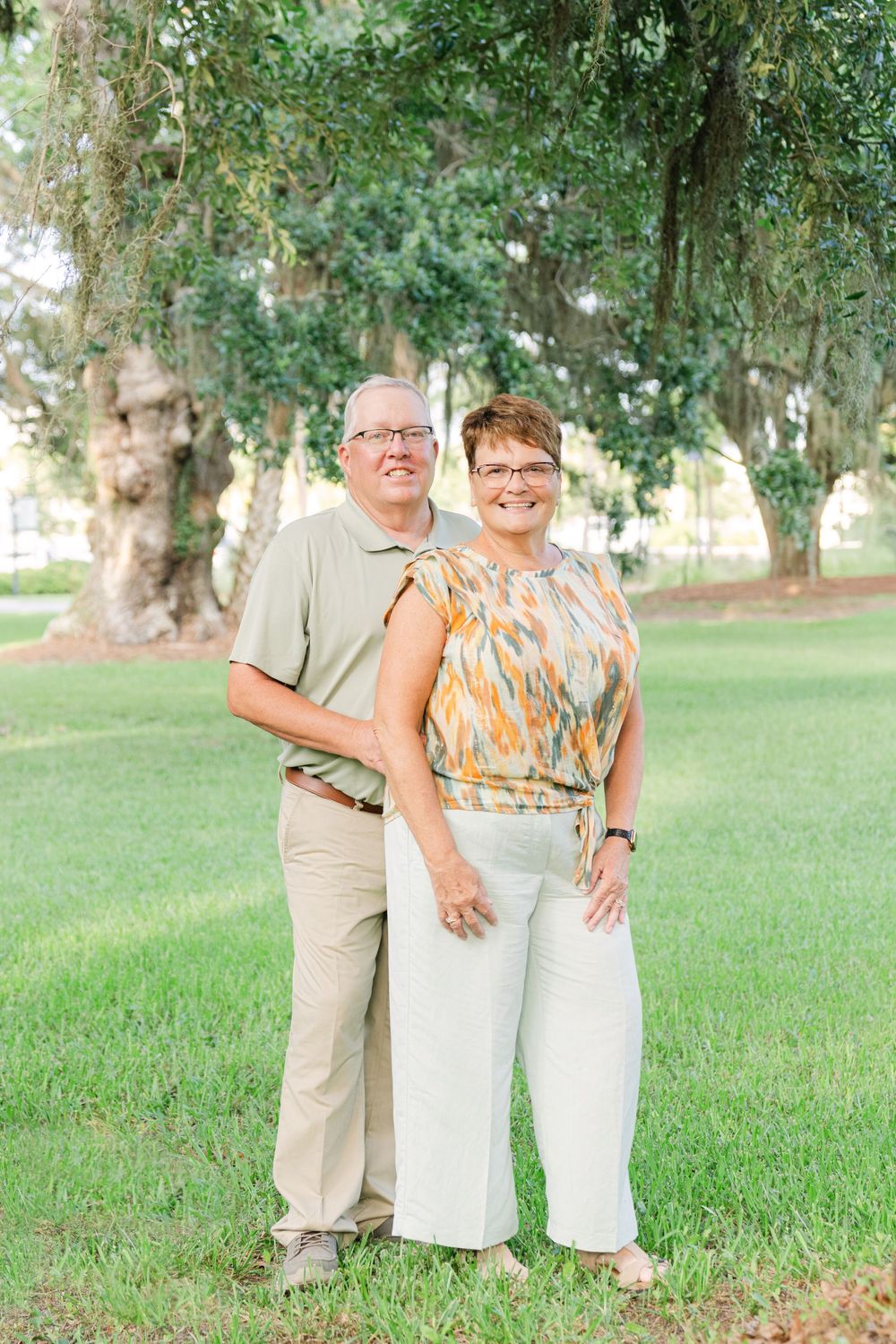 Couple celebrating their wedding anniversary beneath moss-draped oak trees in Jekyll Island’s Historic District