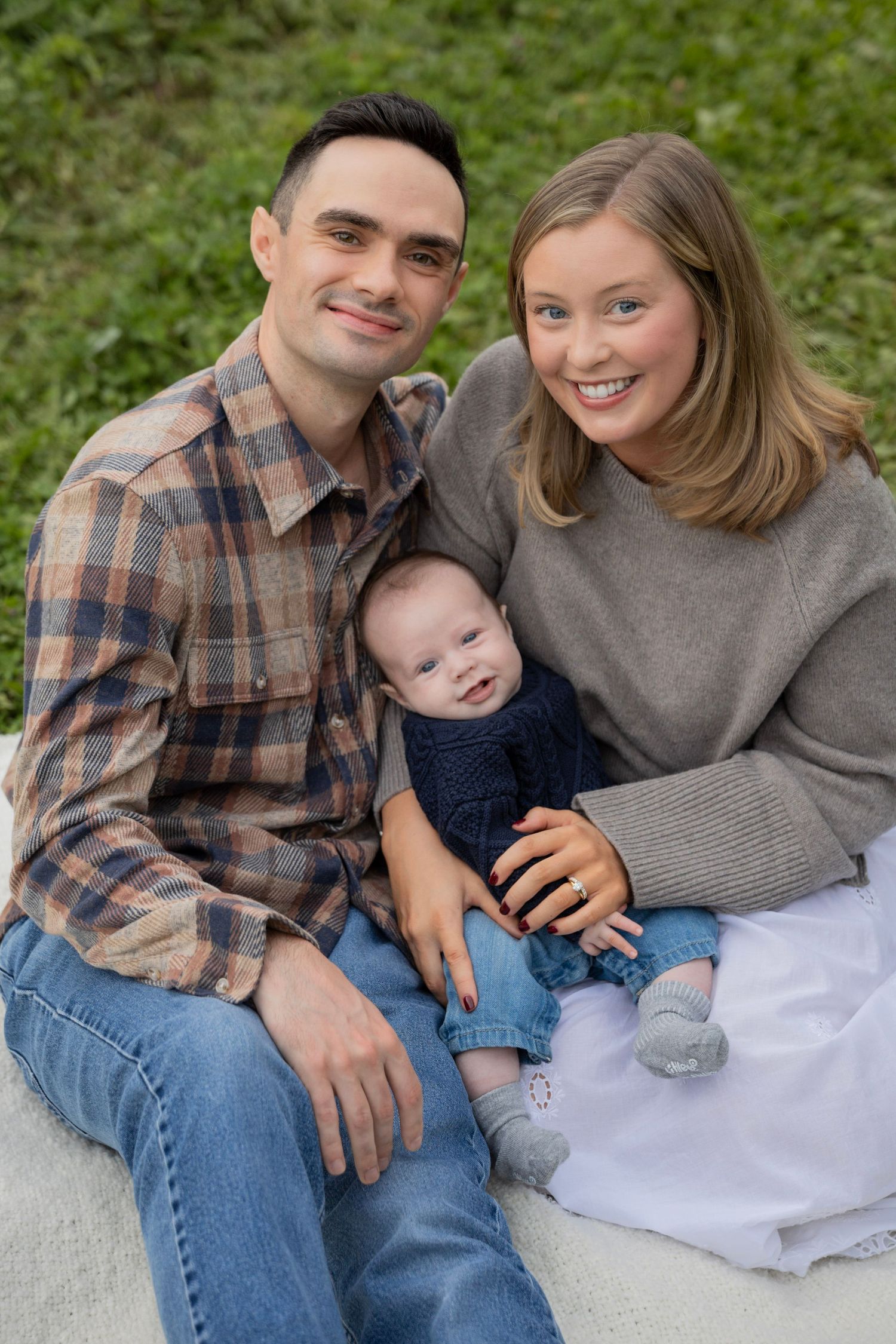 Family smiling during an outdoor photo session