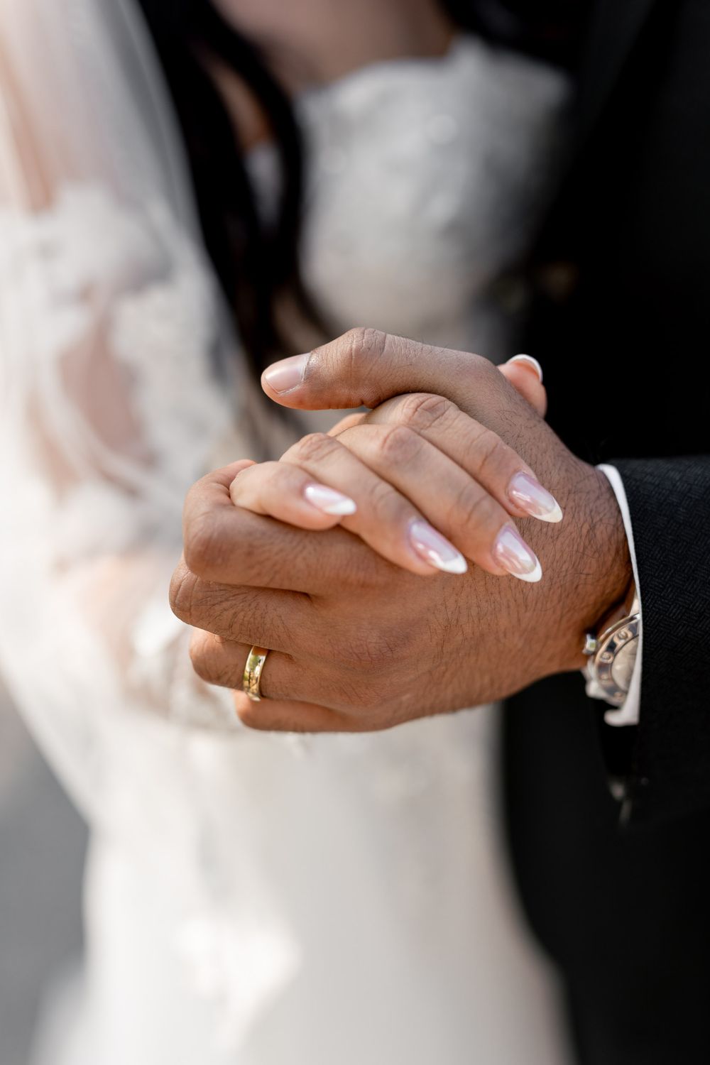 detailed shot of the couple holding hands