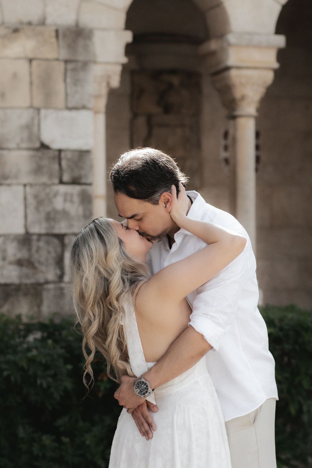 Newlywed engaged couple kissing after proposal in The Ancient Spanish Monastery, Miami Beach