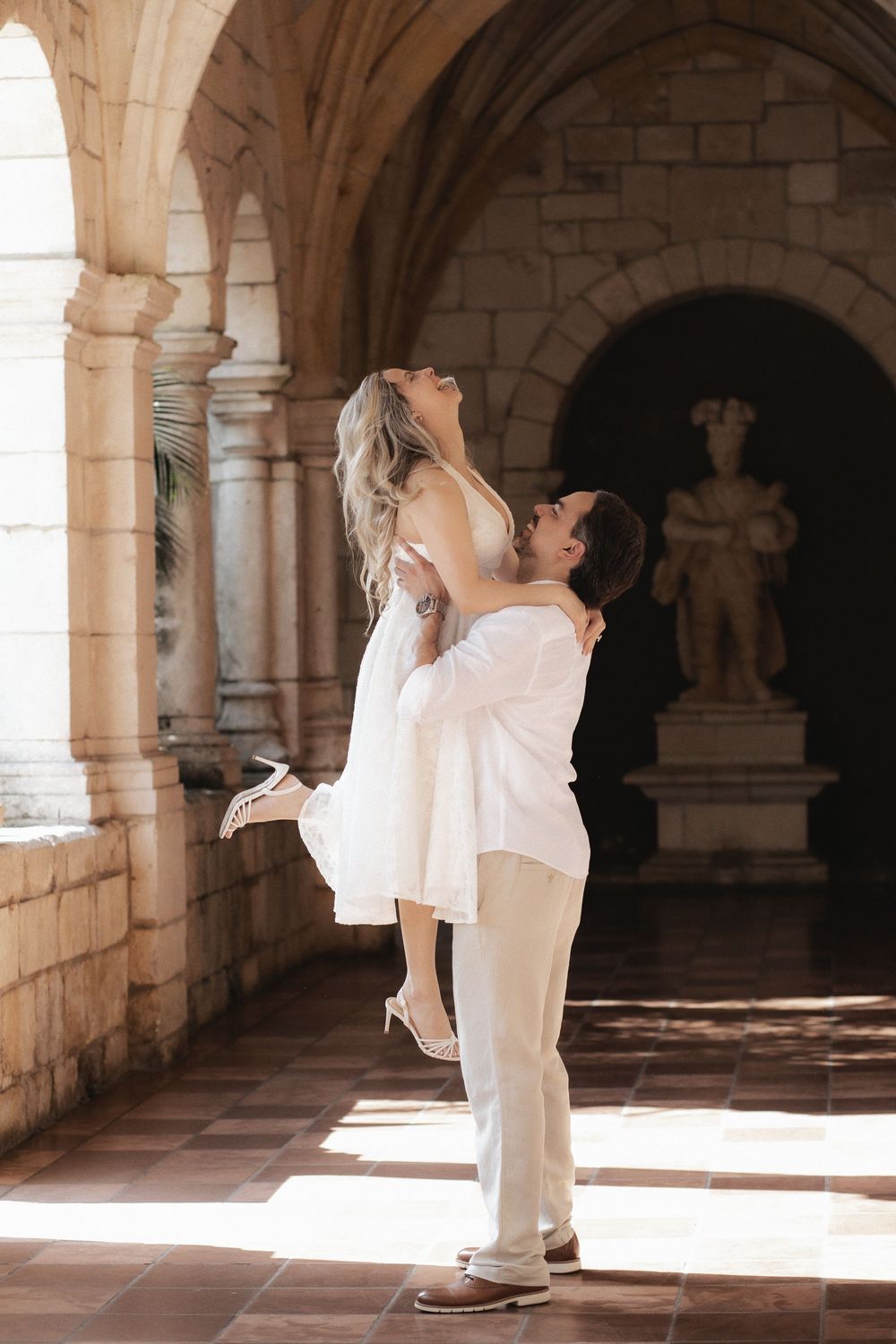 Newlywed engaged couple dancing after proposal in The Ancient Spanish Monastery, Miami Beach