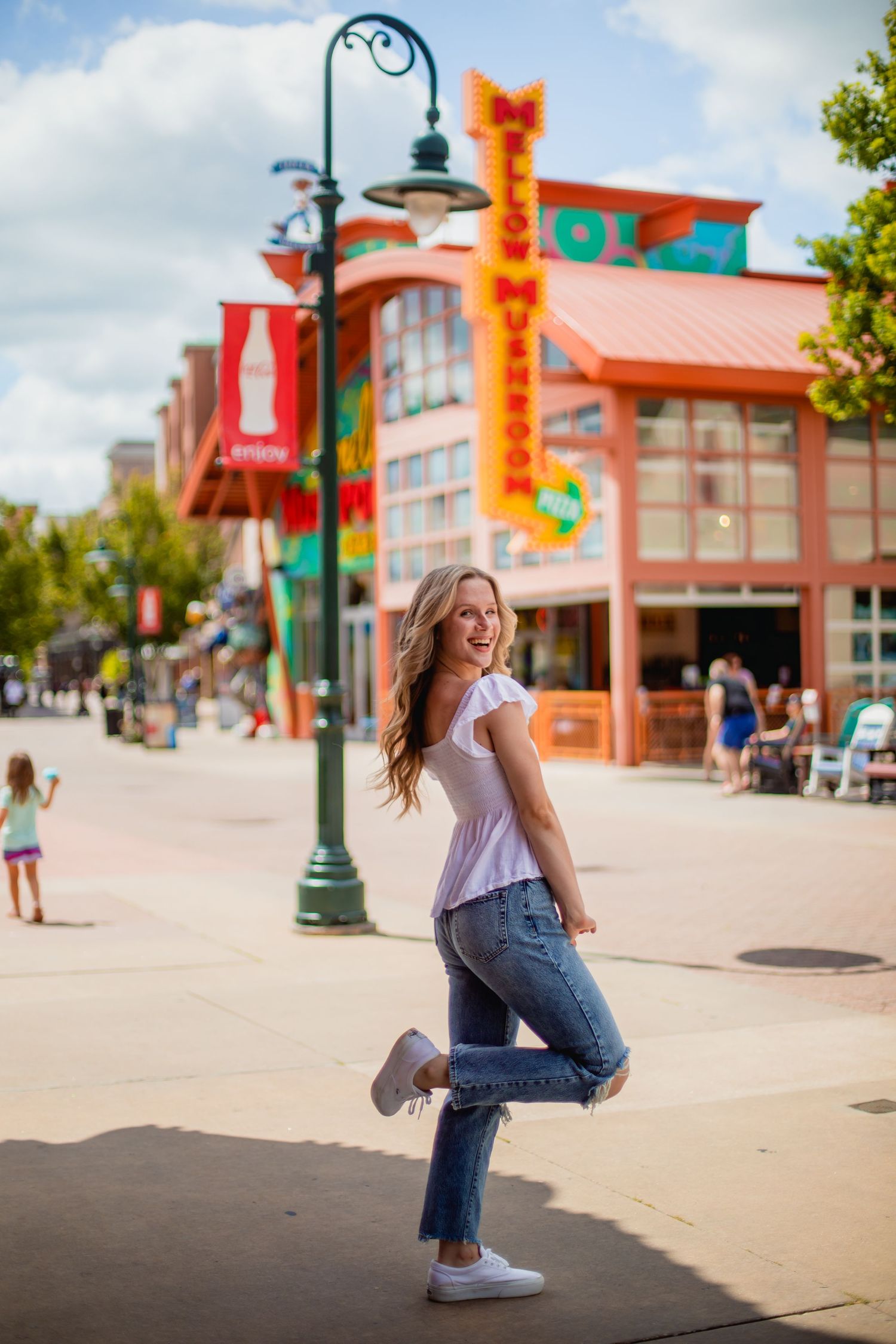 Senior poses for photo on the Branson Landing in Missouri taken by Morgan Lea Photography.