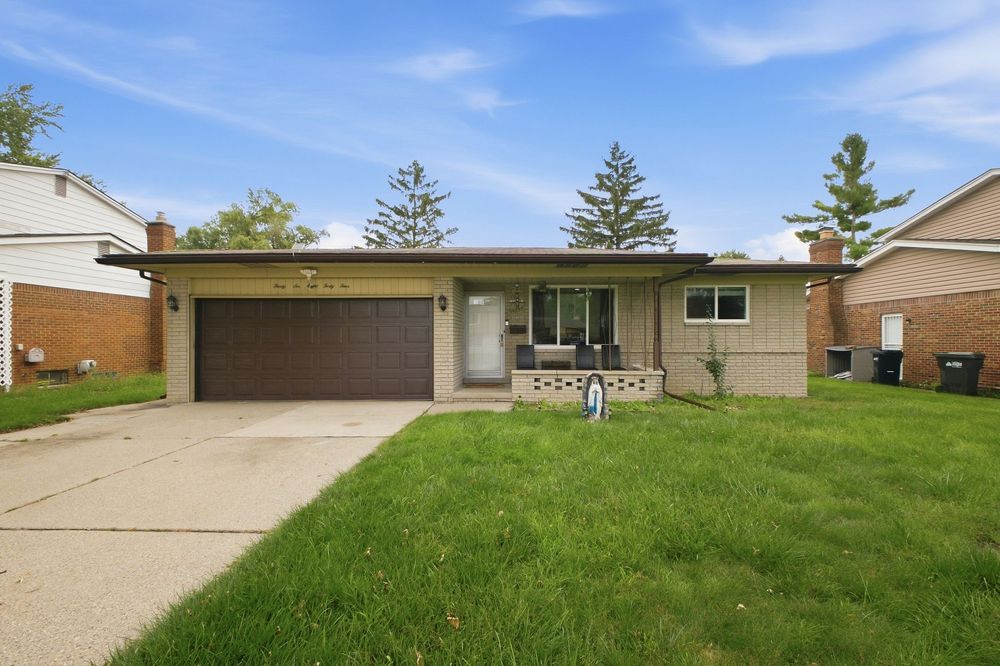 Mid-century ranch home with brown garage door, brick exterior, covered porch, and lush green lawn on a sunny day.