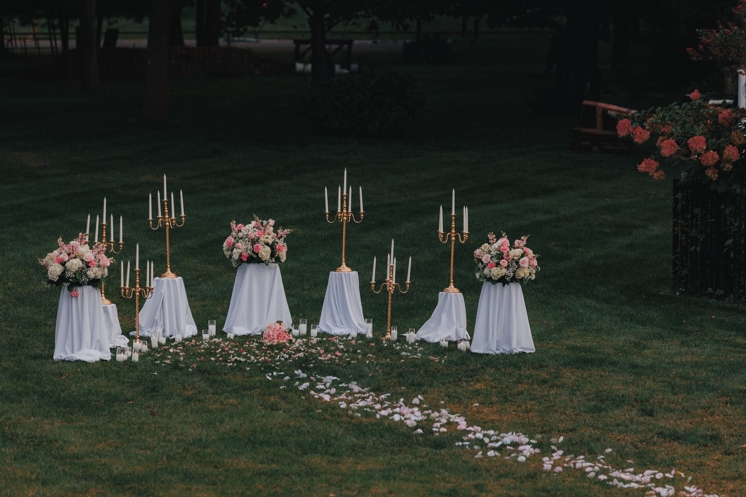 Candlelit marriage proposal setup decorated with floral arrangements in Long Island