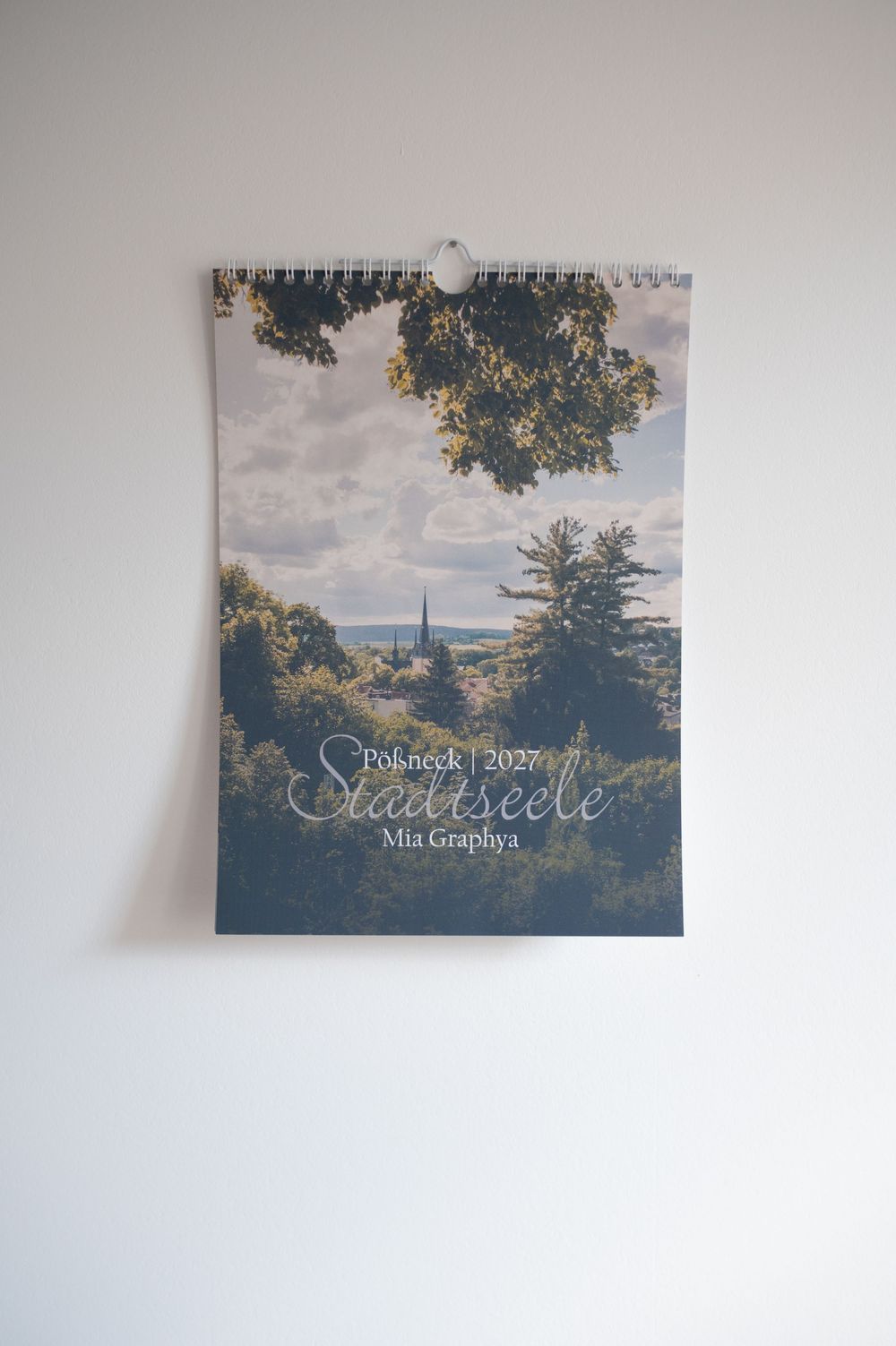 A 2021 wall calendar titled Stadtseele by Mia Graphya featuring a scenic landscape photo of Pößneck, Germany.