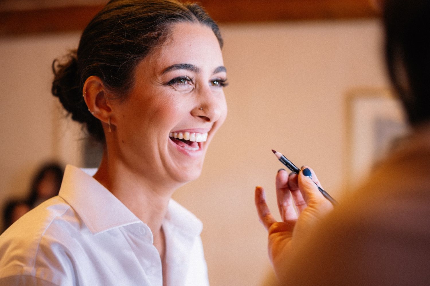 Bride laughing during makeup at her Post Hotel wedding in Lake Louise