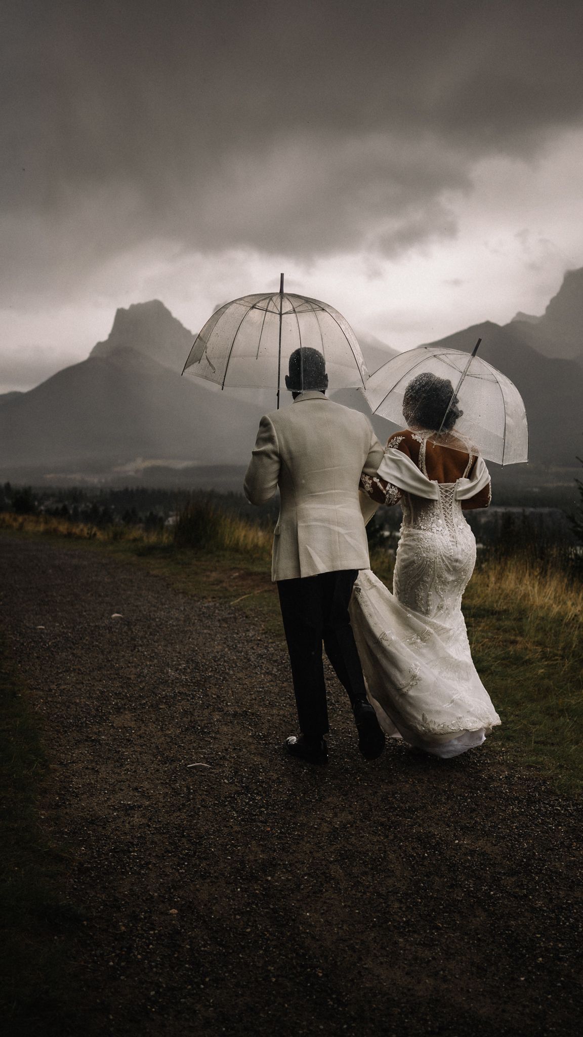 Couple reading private vows under storm clouds in the Canadian Rockies near Canmore
