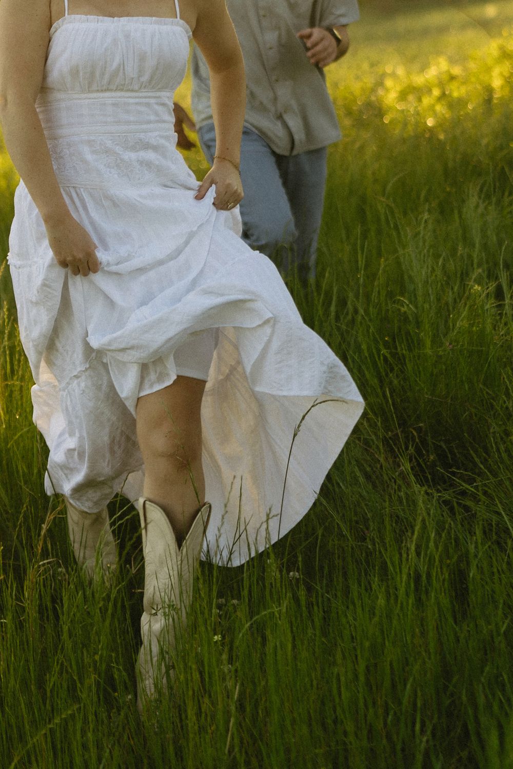 Cinematic detail photo of a future bride running through an open field during engagement session in Georgia.