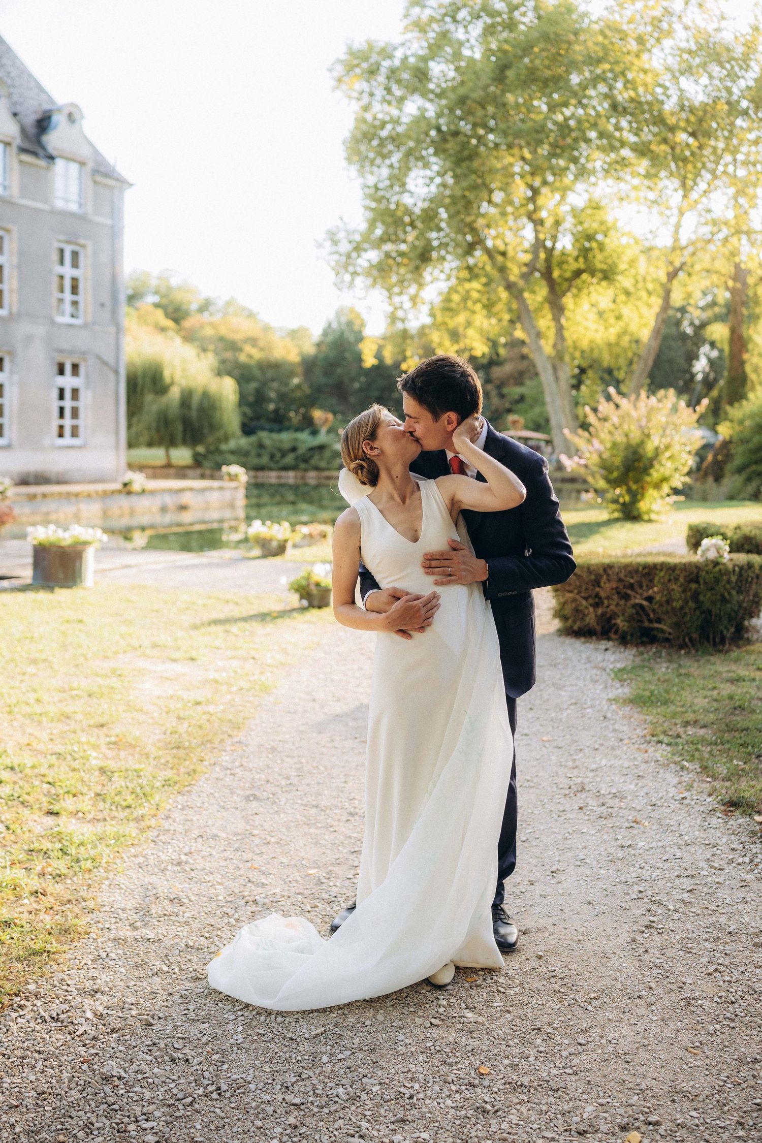 A tender autumn embrace captured during a wedding photoshoot with fall foliage.