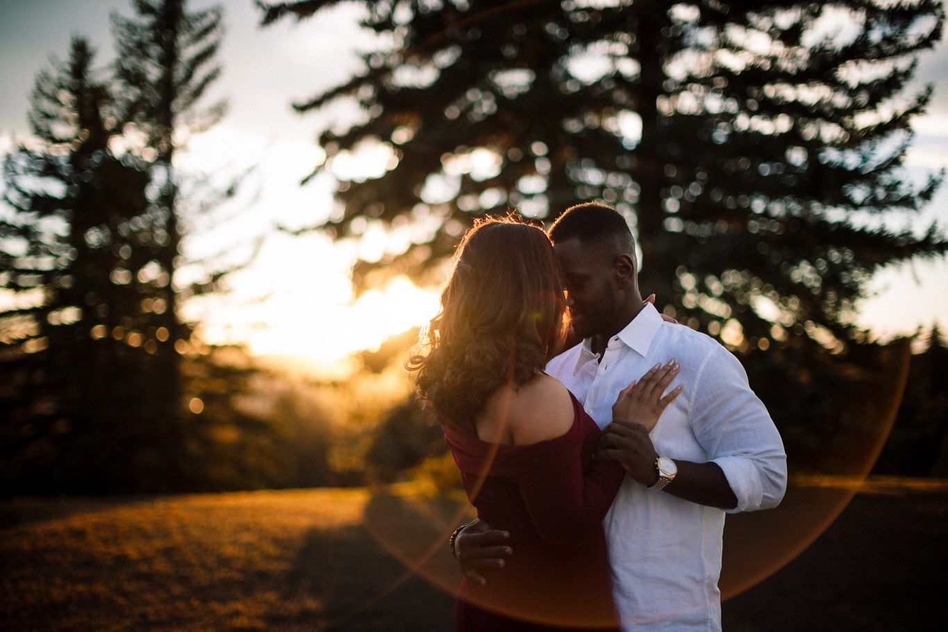Couple embracing at golden hour during their engagement session