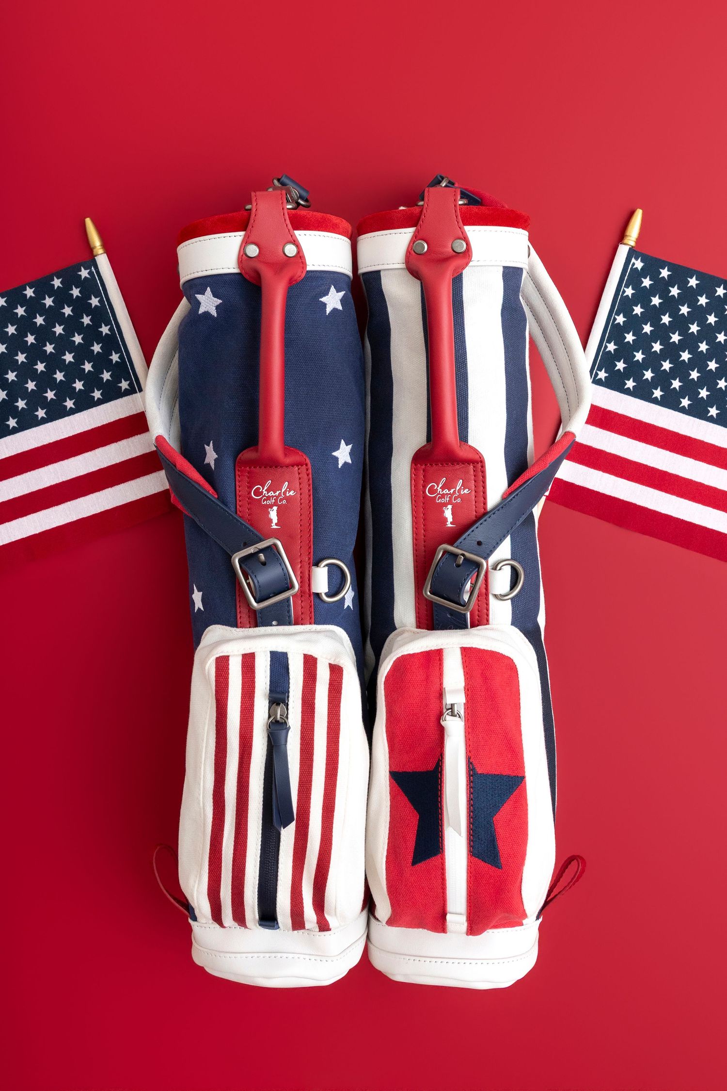 Patriotic red, white, and blue golf bags with American flag motif and US flags on red background.