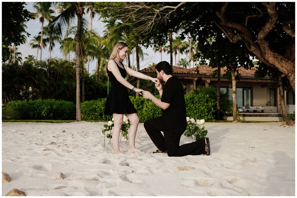 Bride and groom celebrating their proposal on the beach during a luxury engagement session in Punta Mita.