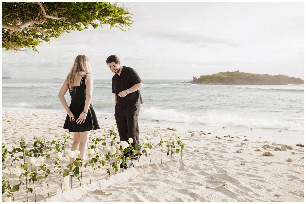 Couple during their St Regis Punta Mita Engagement Photographer session on a tropical beach with ocean views and coastal landscape.