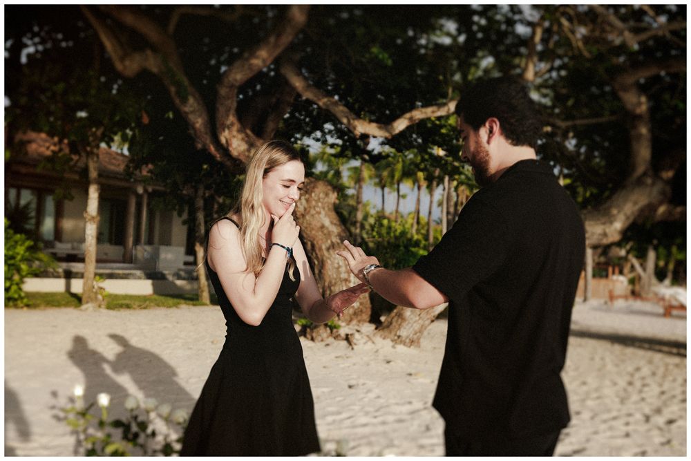Couple sharing a romantic moment on the beach during their destination engagement session in Punta Mita.