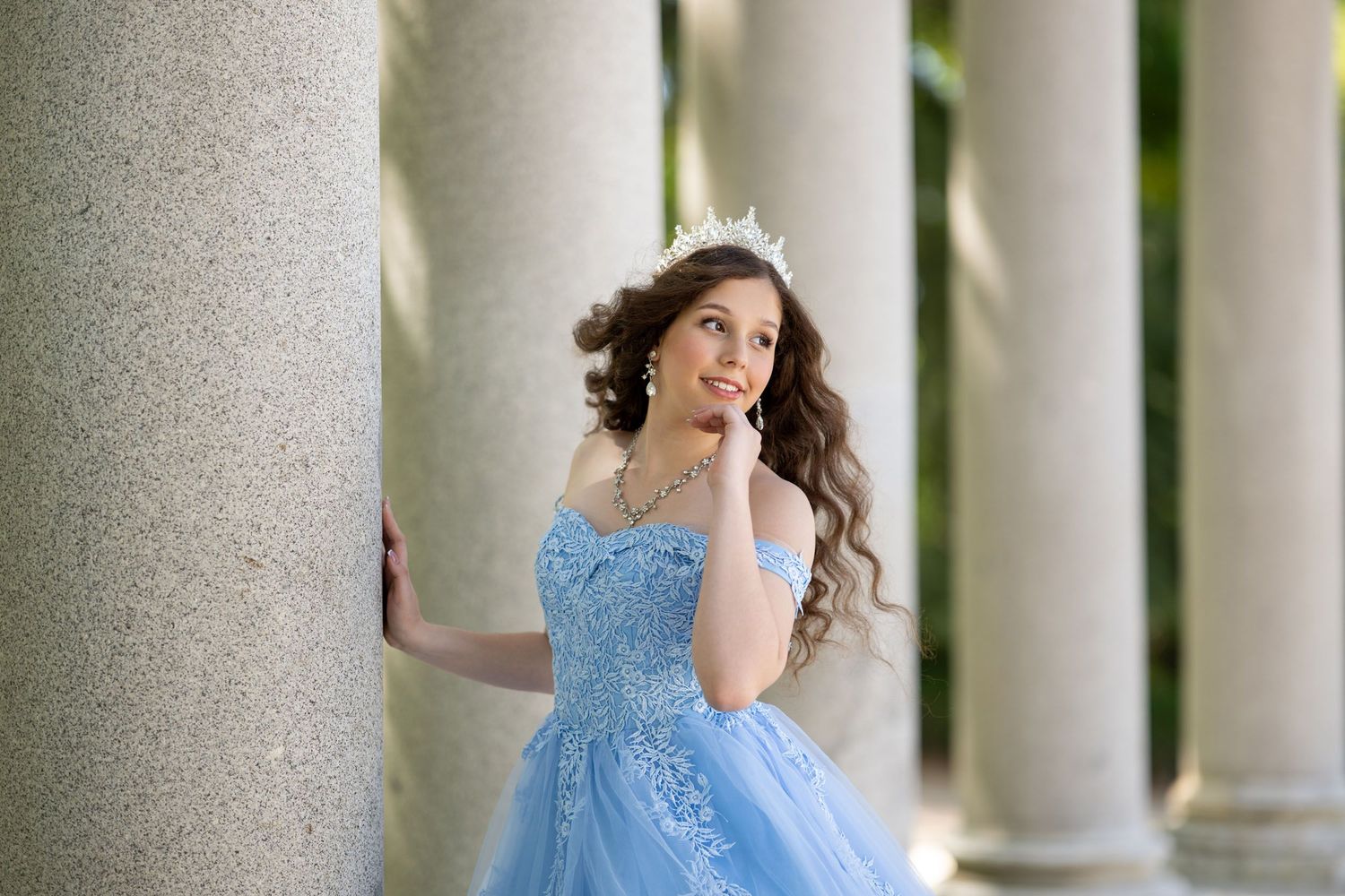 A flowing blue dress creates an ethereal silhouette against the stunning backdrop of Madrid's Almudena Cathedral at sunset.
