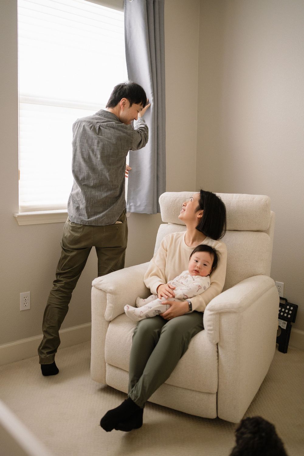Series of candid family interactions on a cream-colored armchair in a minimalist room.