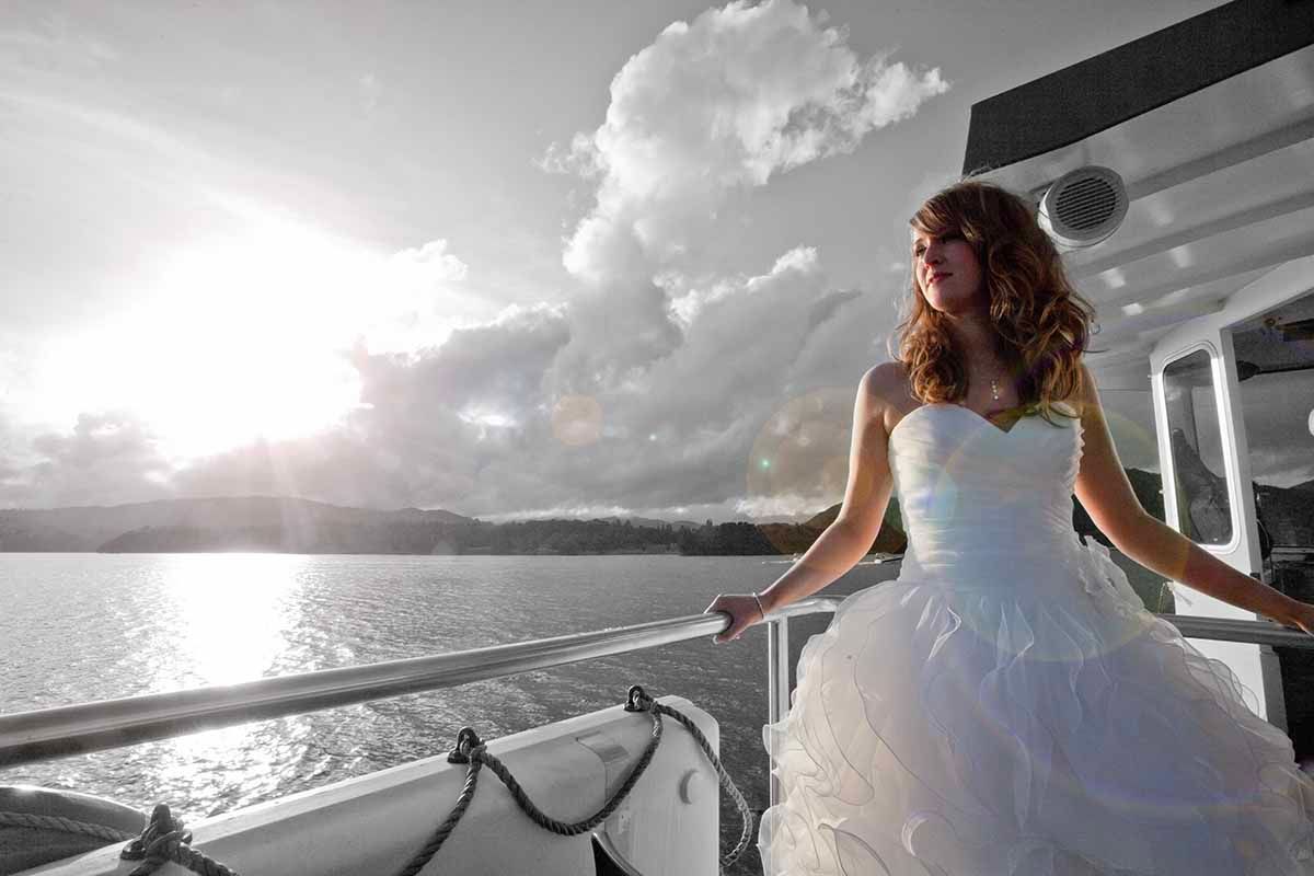 Bride on the deck of the famous Windermere steamer as the bridal party takes a tour of the lake.