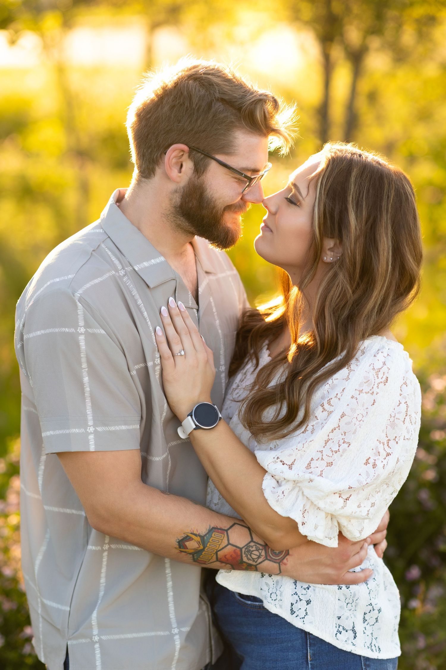 A romantic couple embraces in golden sunlight, gazing into each other's eyes with a warm autumn backdrop.
