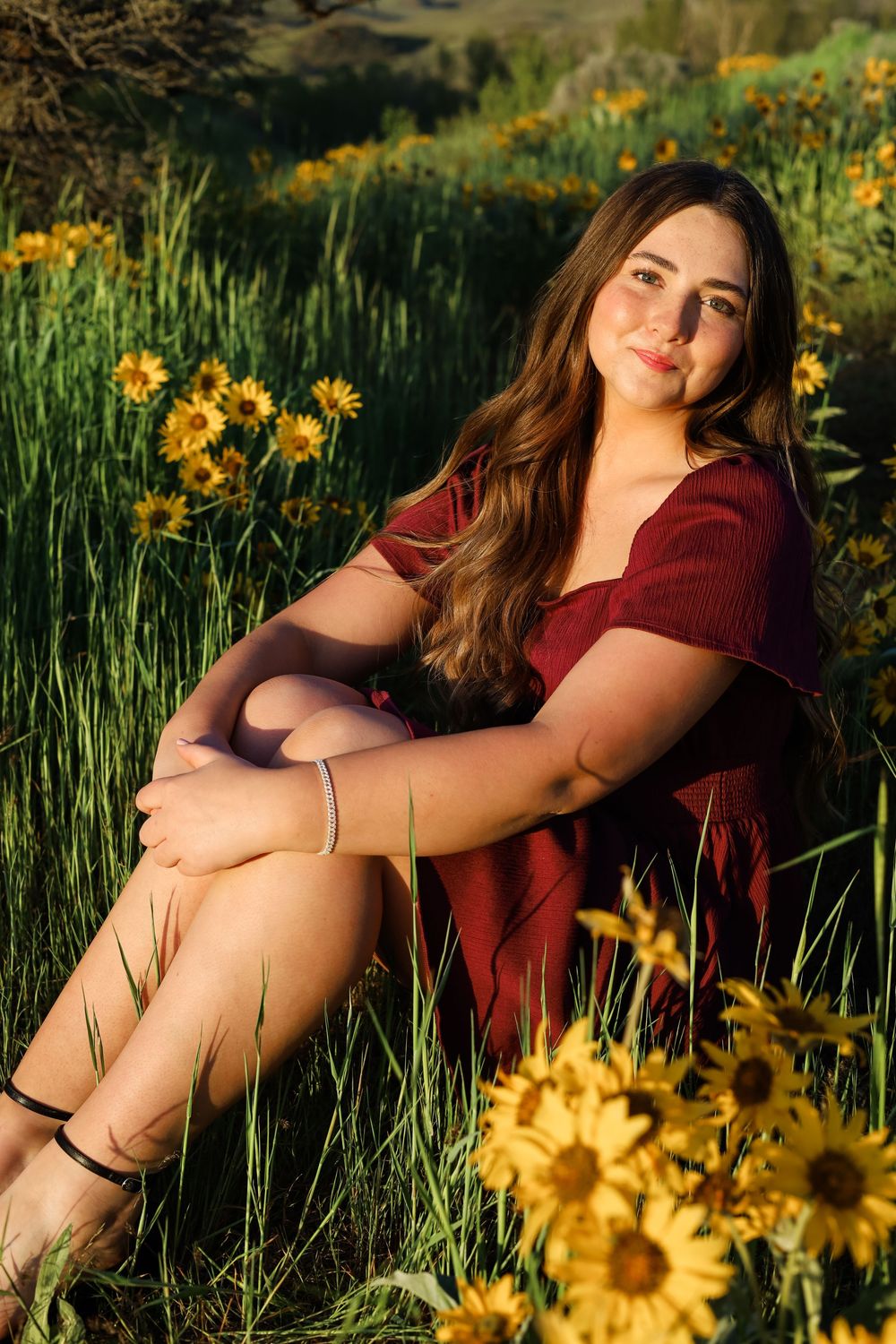 A photoshoot in a field of sunflowers at golden hour showcasing casual summer fashion.