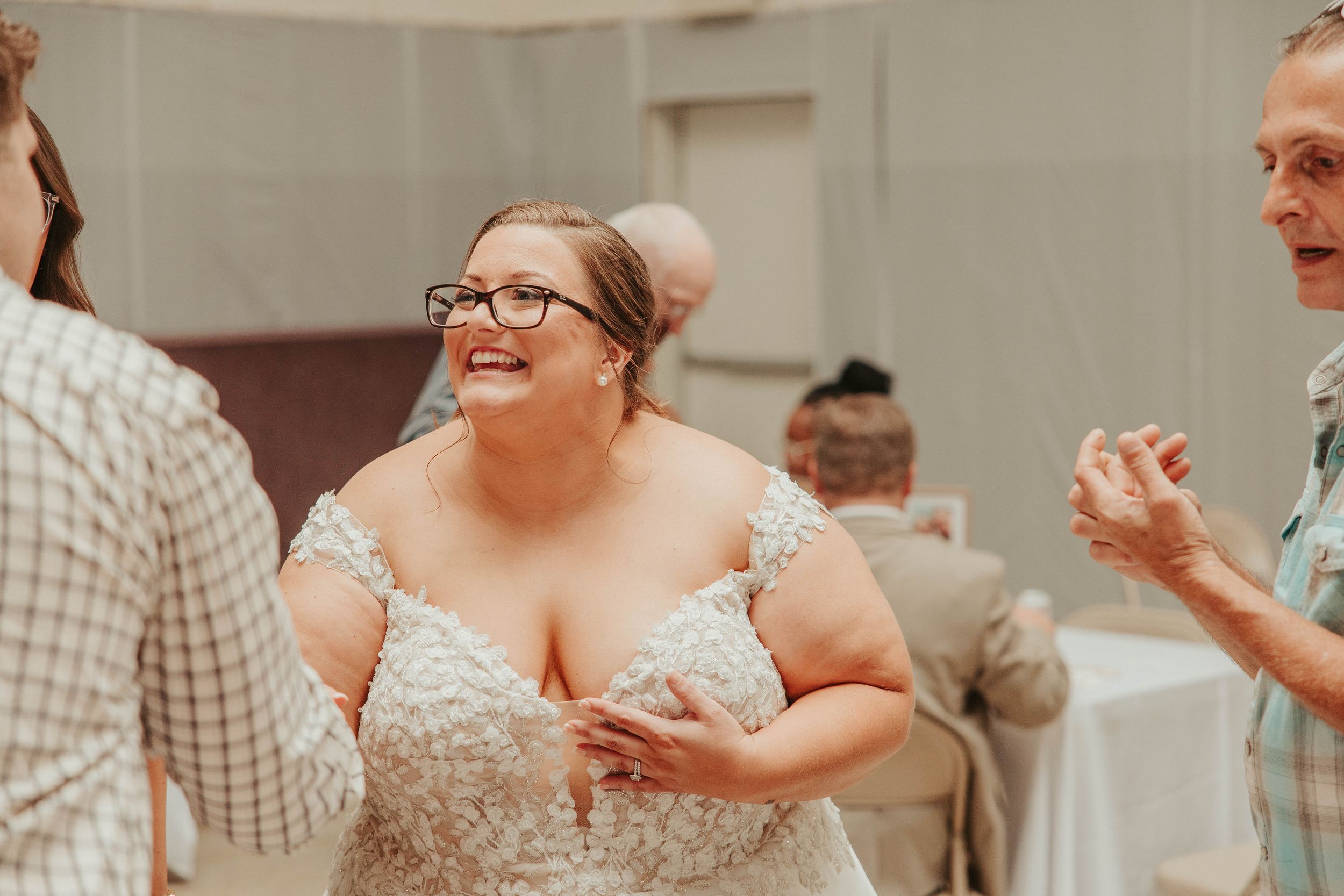 Joyful dancing and celebrations during indoor wedding reception party.