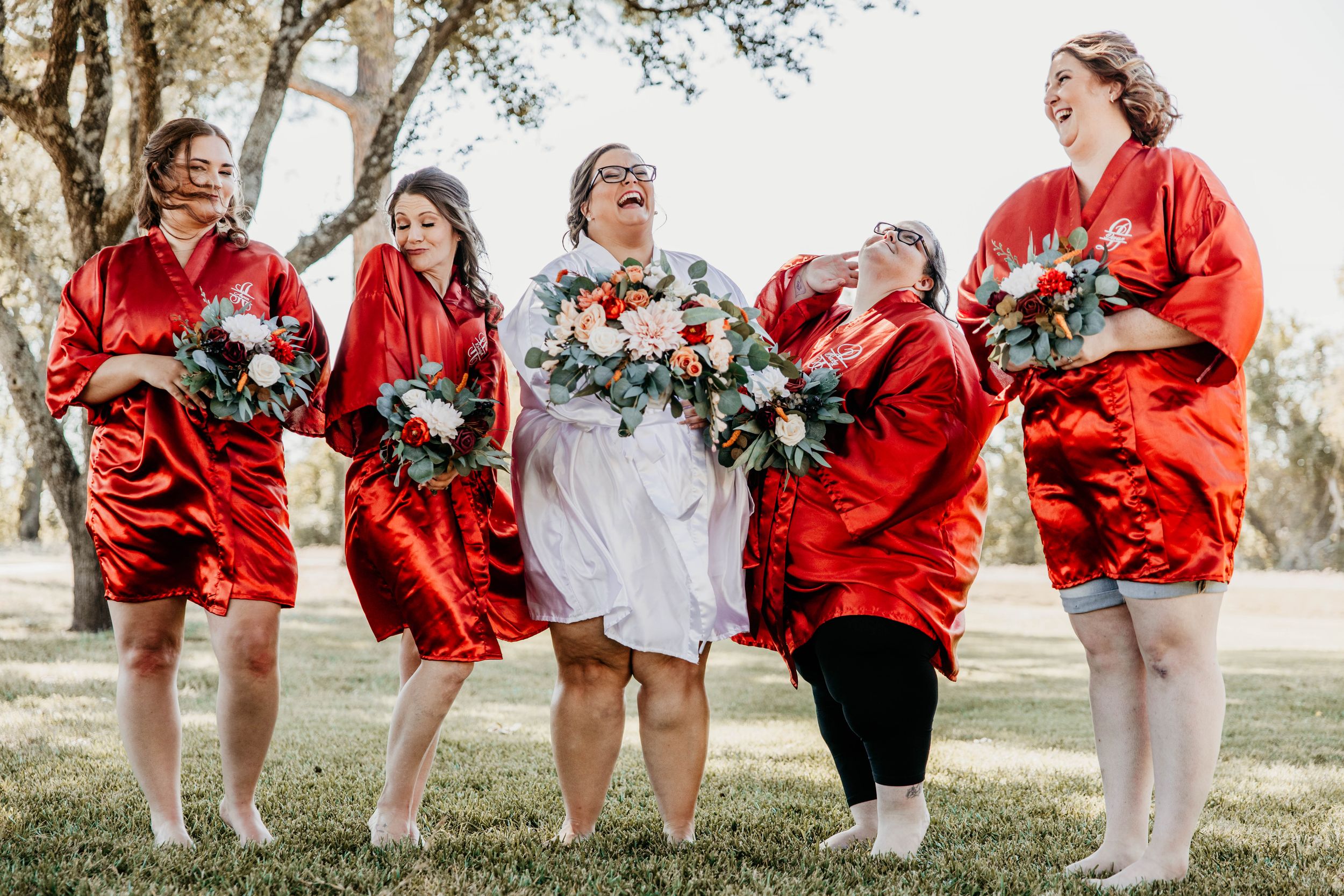 Group wearing red wraps shows off their outfits in a fun outdoor photo sequence.