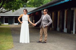 Cherie DeVaux in white gown and David Ingordo in plaid blazer walk hold hands outside at Fasig-Tipton in Saratoga Springs, NY for Wedding