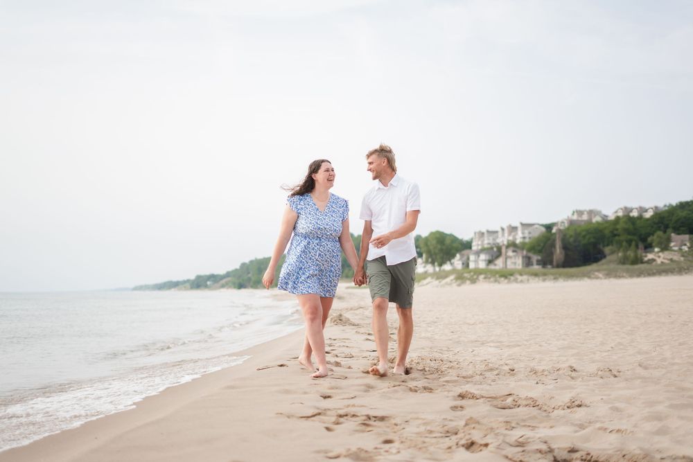 A couple taking a walk on the beach.