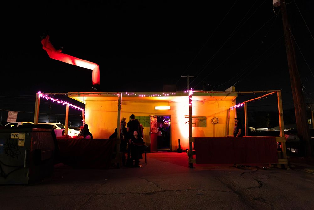 A photo of the entrance of a small dive bar.