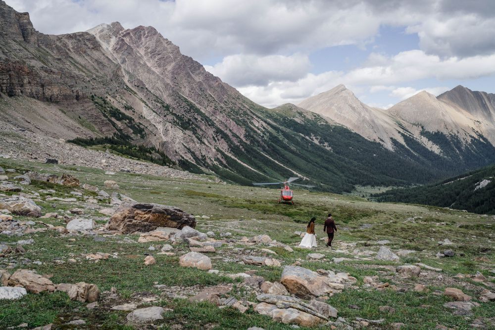 Scenic mountain hiking trail with distant peaks and alpine meadow in the foreground.