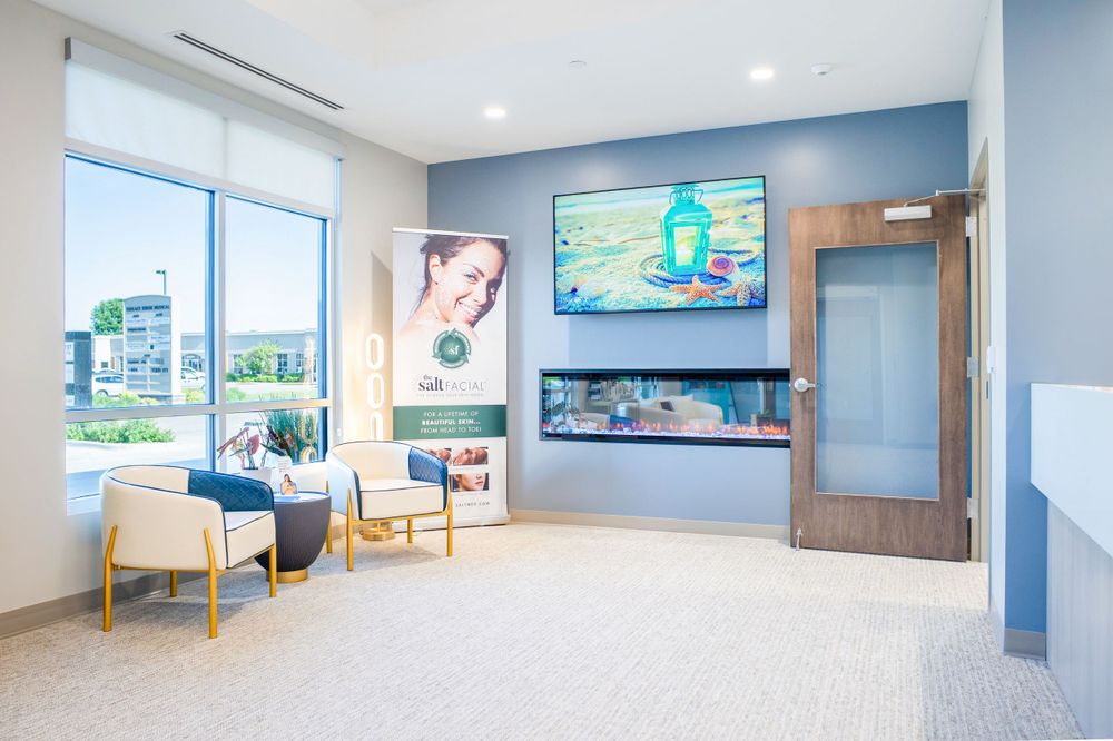 Modern medical office waiting room with mounted TV and contemporary decor. Quad Cities Real Estate Photography