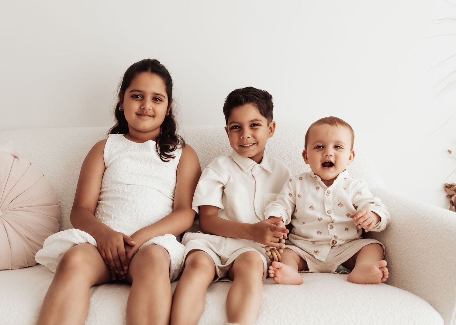 A series of candid lifestyle photos showing people relaxing together on a white couch.
