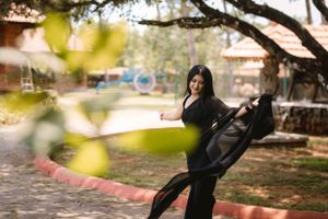 Playful outdoor portraits taken under a tree with natural sunlight filtering through leaves.