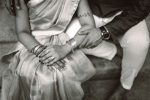 Candid black and white photographs showing casual seated poses and hand details.