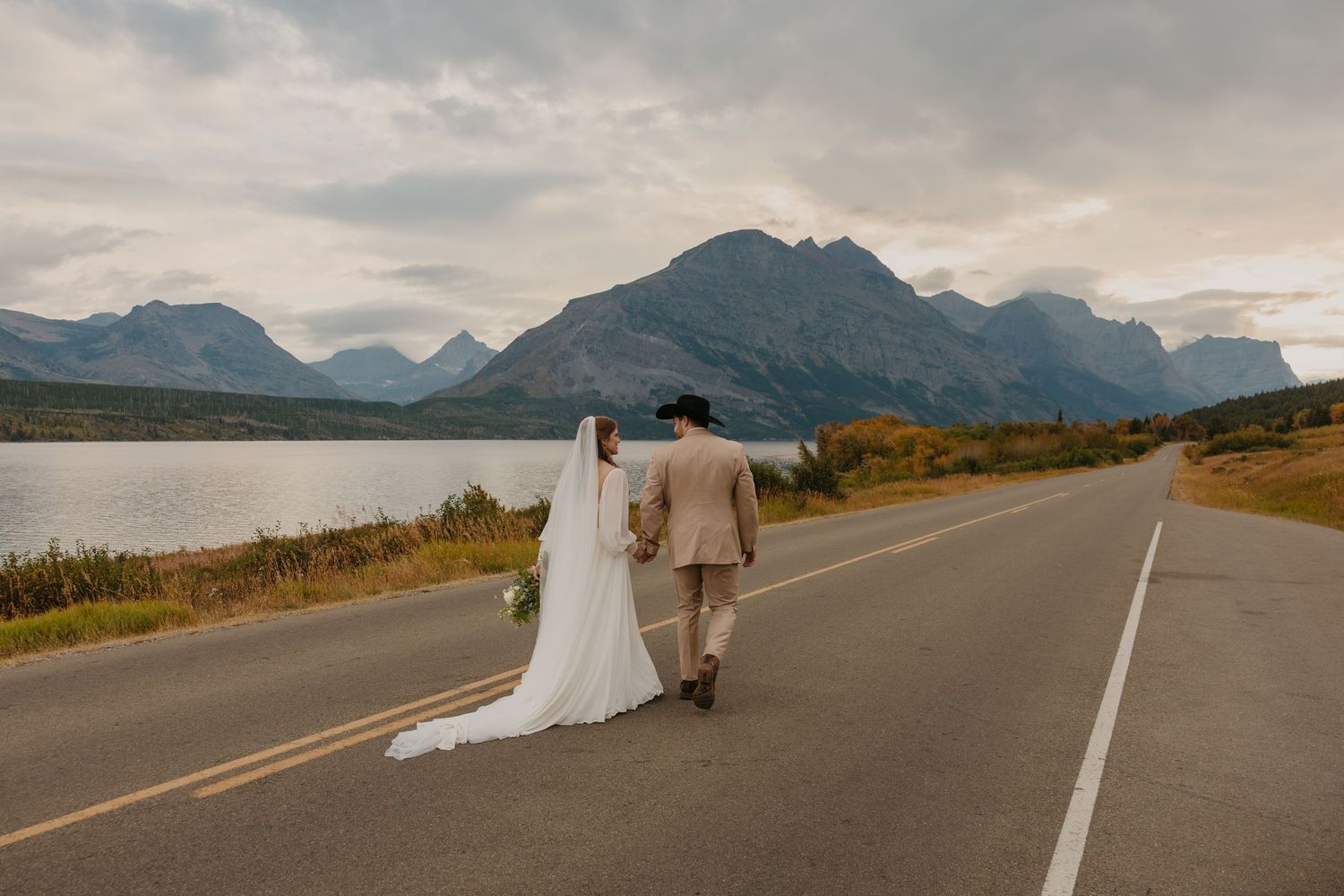 Glacier National Park Elopement Photographer captures sunset as the couple explores the blue hour with lanterns. Glacier National Park