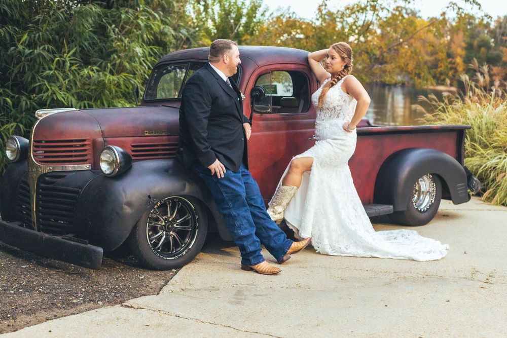 Classic vintage cars parked alongside wedding couple during rustic outdoor photoshoot at The Waterfront in Pasadena, Maryland.