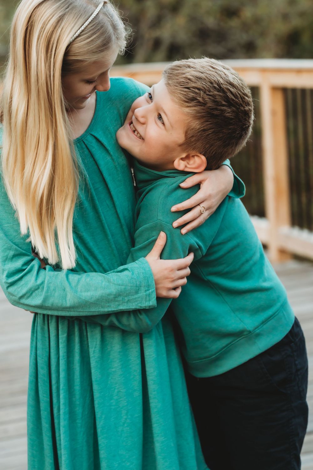 Tender family moment captured in sequence of embraces on wooden deck.