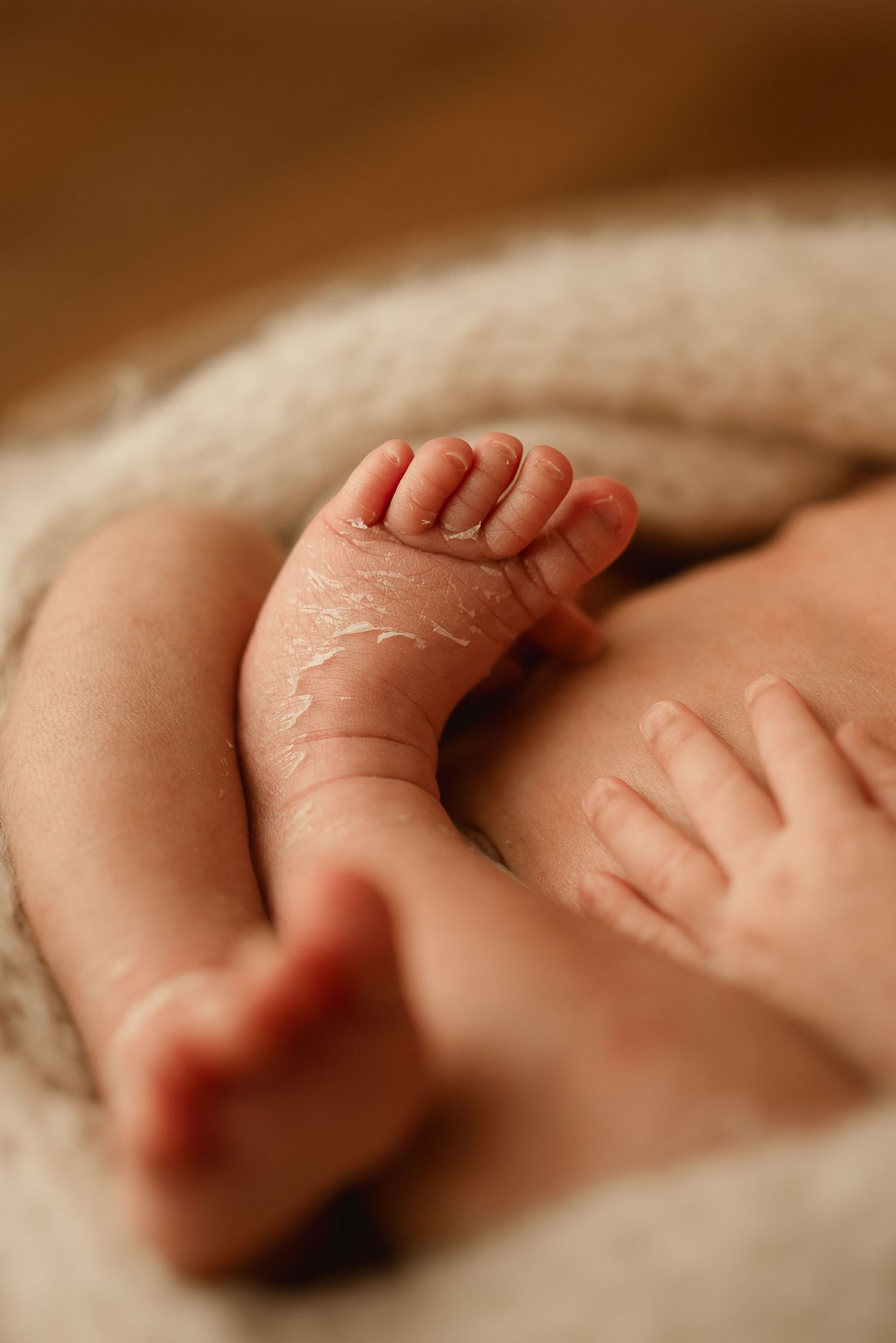 Precious tiny newborn flaky baby toes and feet captured during newborn photoshoot in Clarksville Tennessee studio.