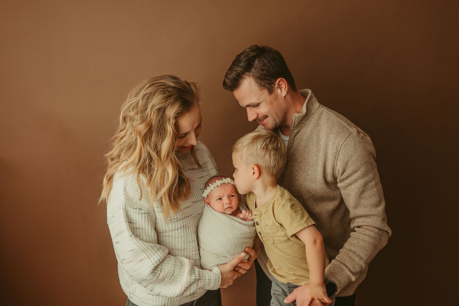 Beautiful new Fort Campbell military family poses with newborn baby girl during studio newborn photography session in Clarksville, TN
