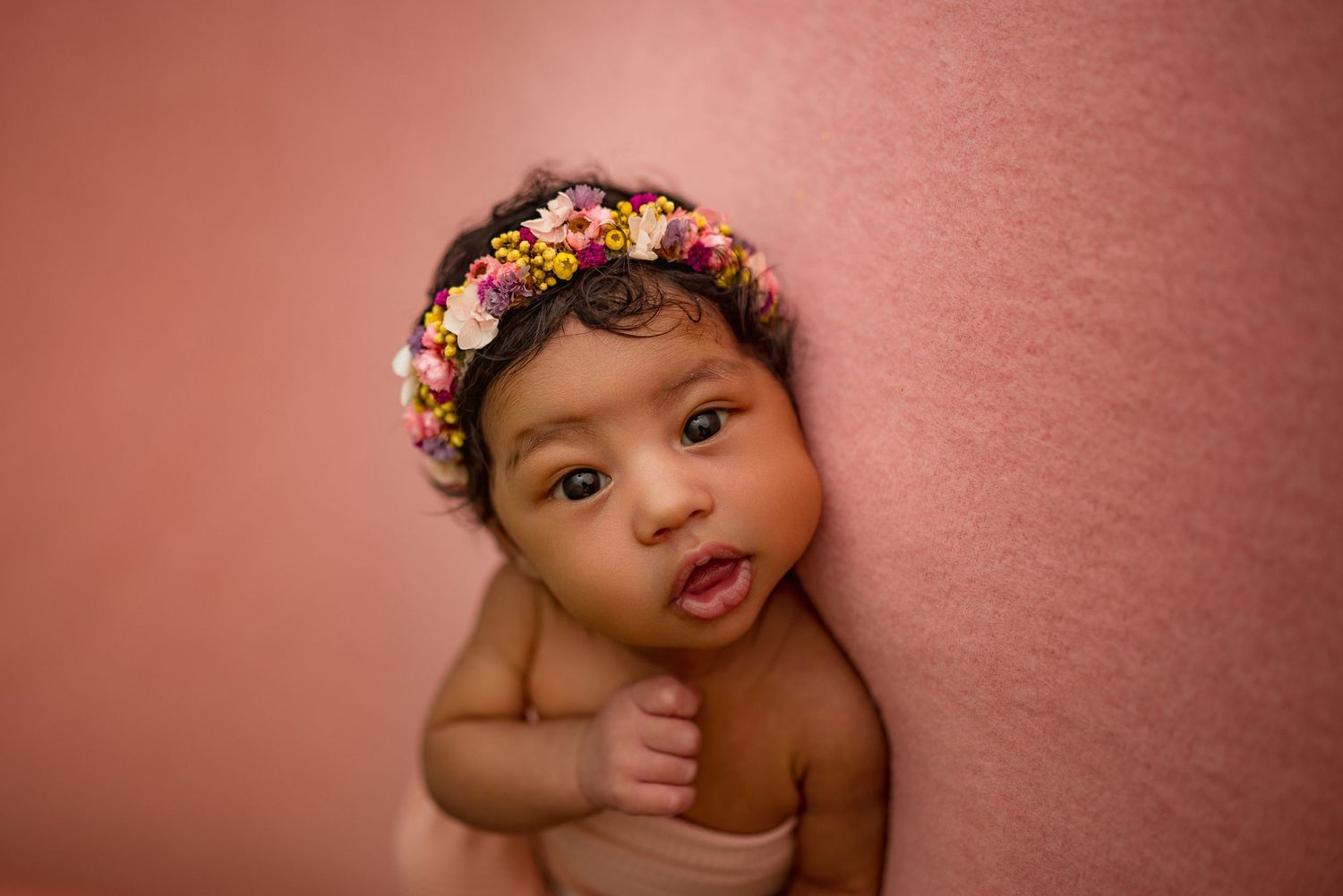 Baby girl makes eye contact with camera during newborn session in Clarksville, Tennessee by Disney Magic Photography.