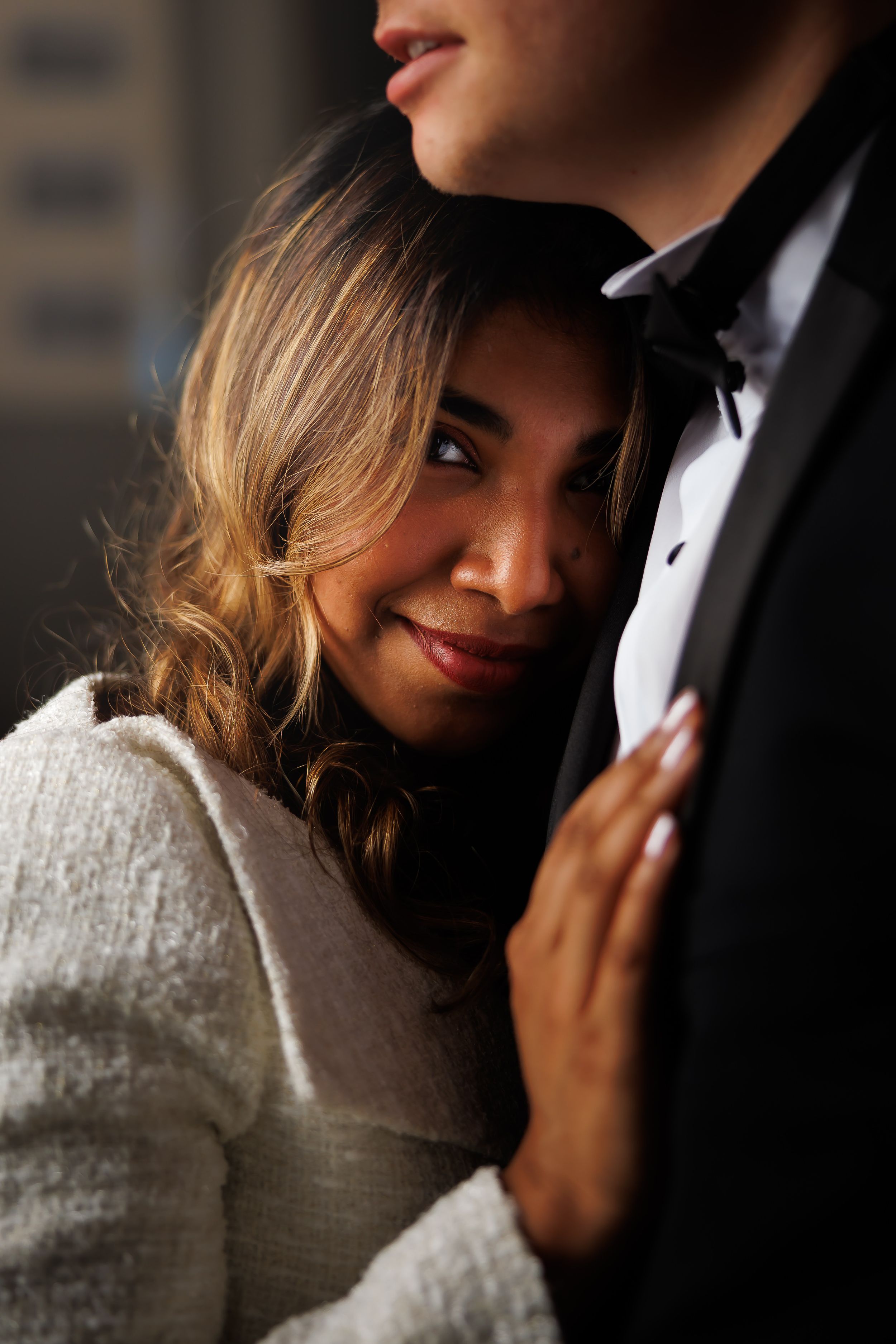 A romantic close-up portrait of a couple in formal attire sharing an intimate moment.