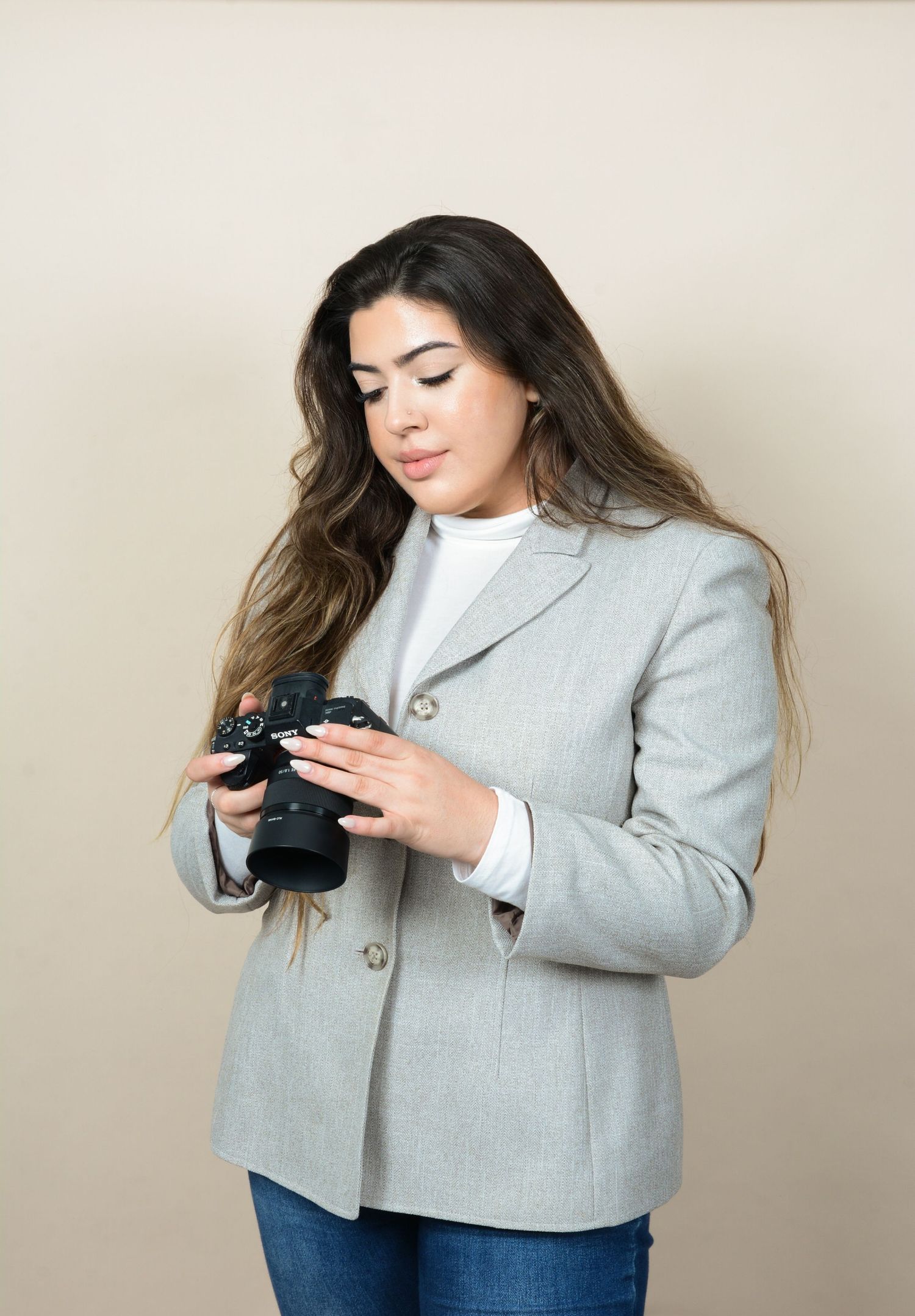 Professional photoshoot featuring gray blazer against neutral background.