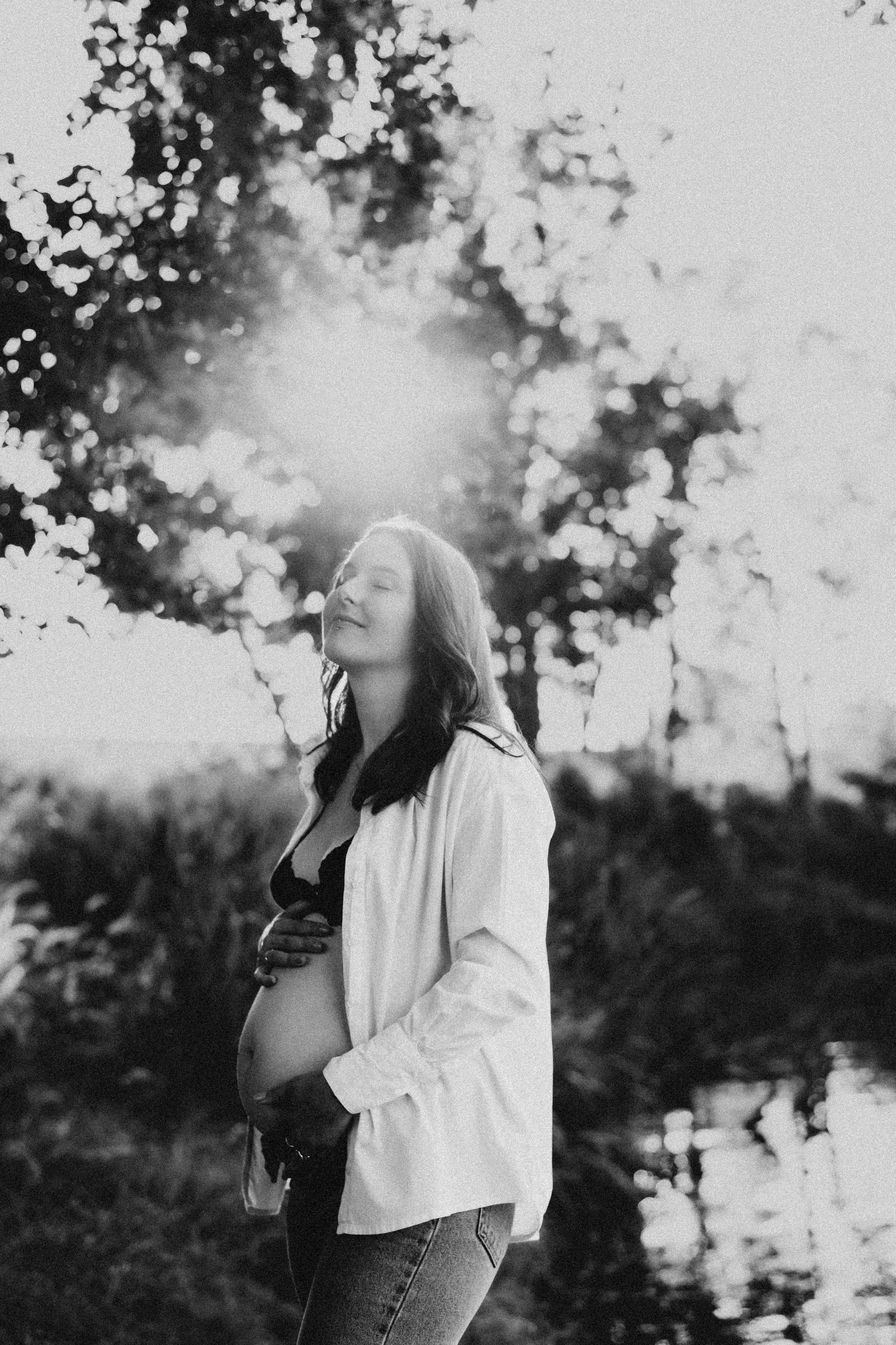 Black and white maternity photo of an expectant mother in nature.